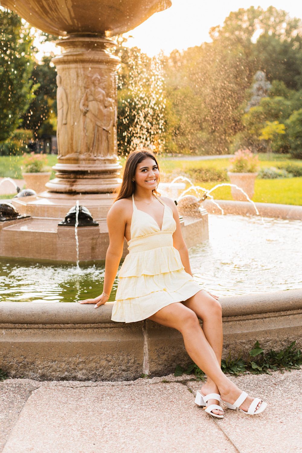 A series of stylish outdoor portrait photos taken by a decorative stone fountain at golden hour.