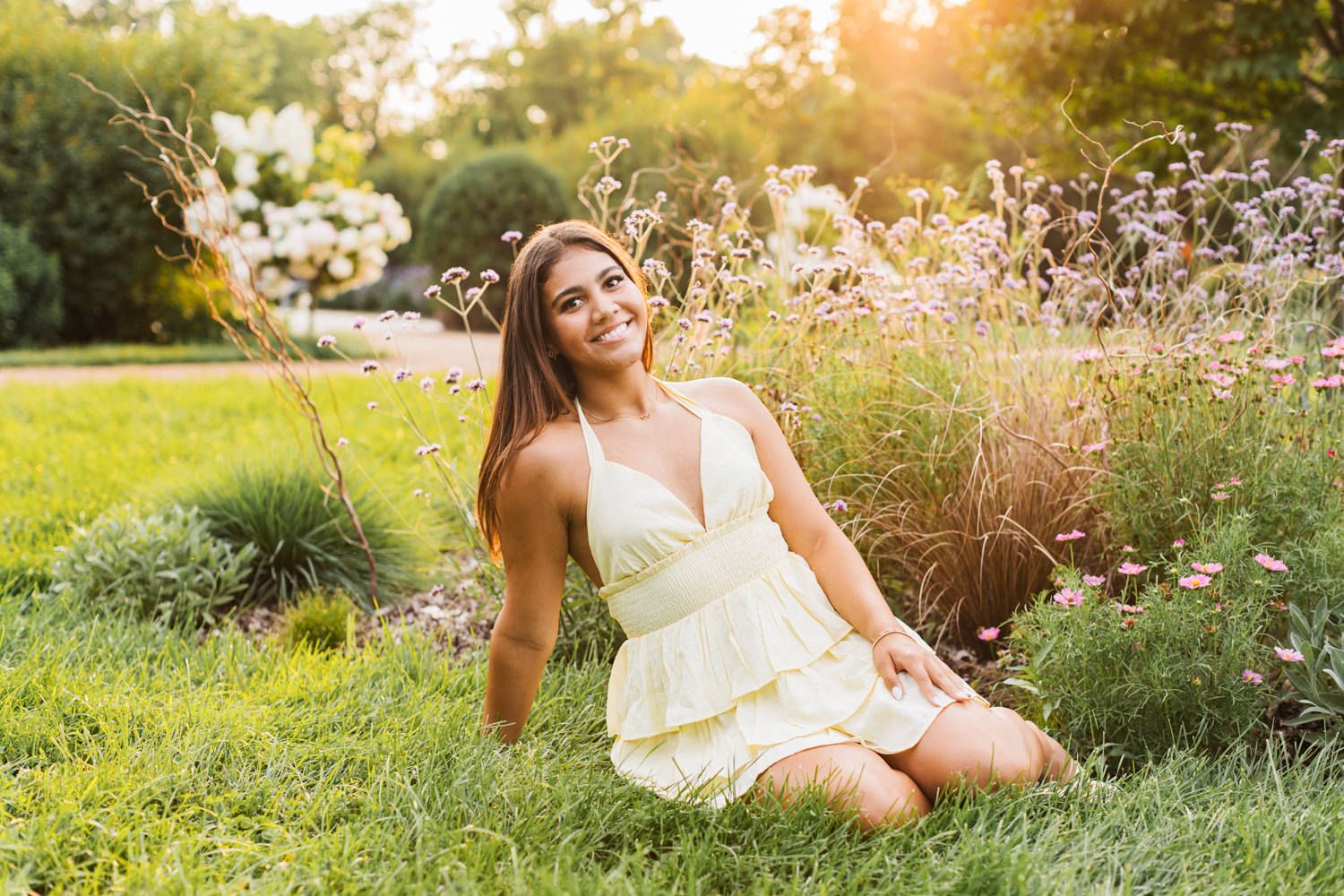Outdoor lifestyle photography in garden setting with natural sunlight and wildflowers.
