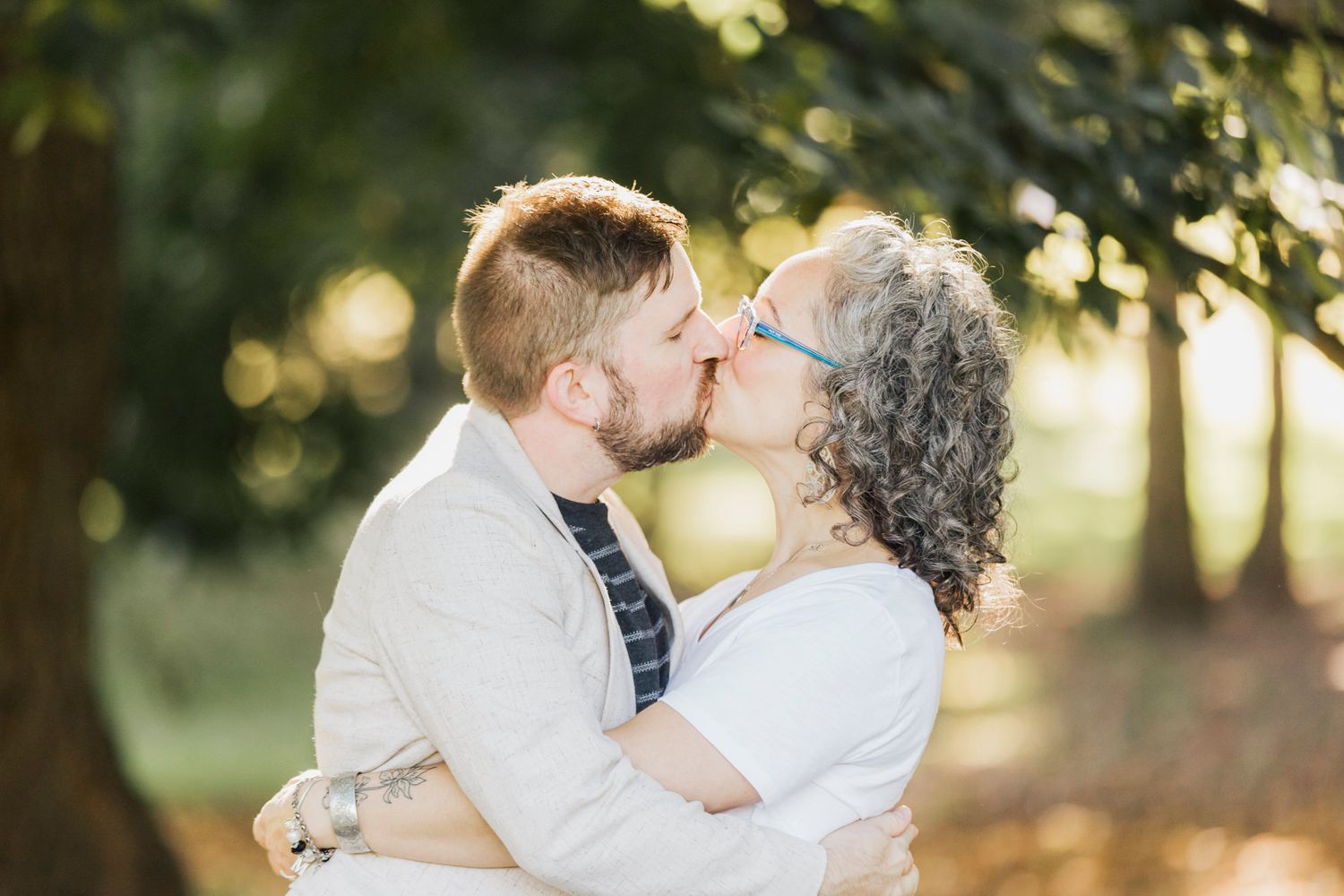 Intimate moments captured between couples during outdoor photo session at sunset.