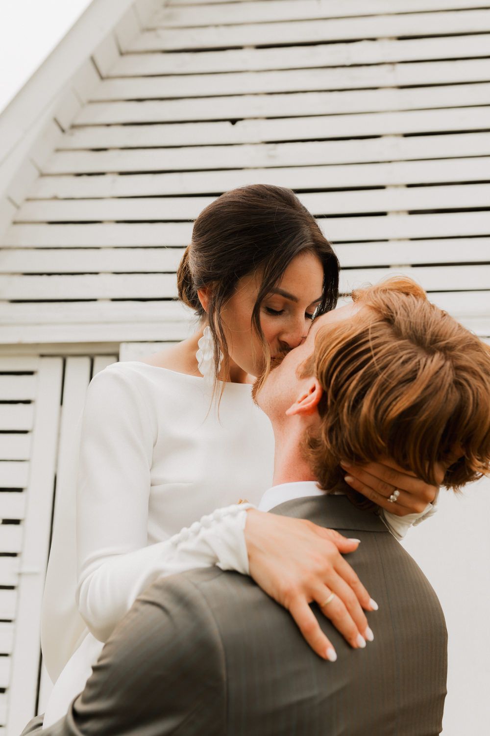 Romantic couple sharing intimate embraces in sequence against white slatted wall background.