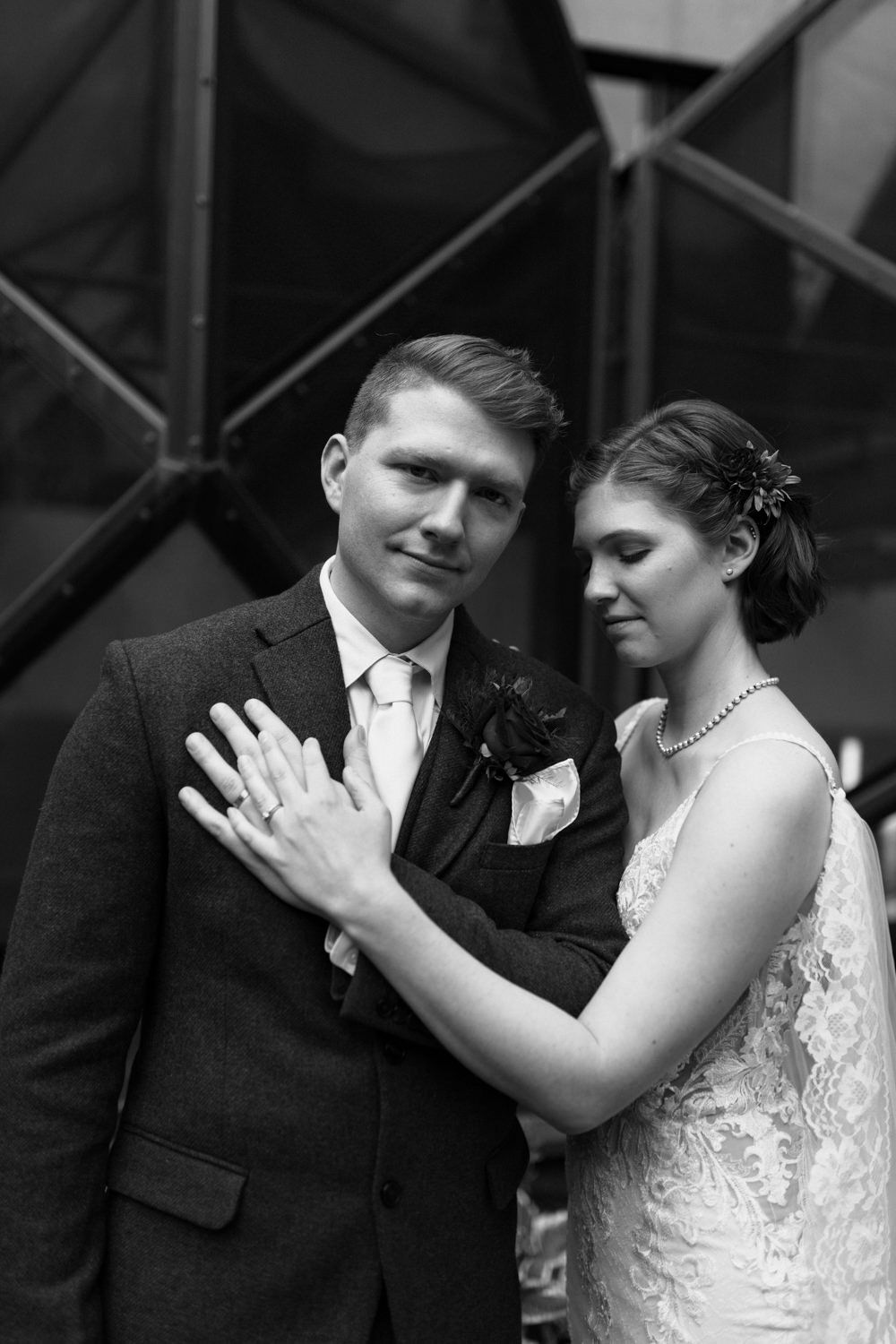 Black and white romantic wedding portrait showing tender moment between newlyweds.