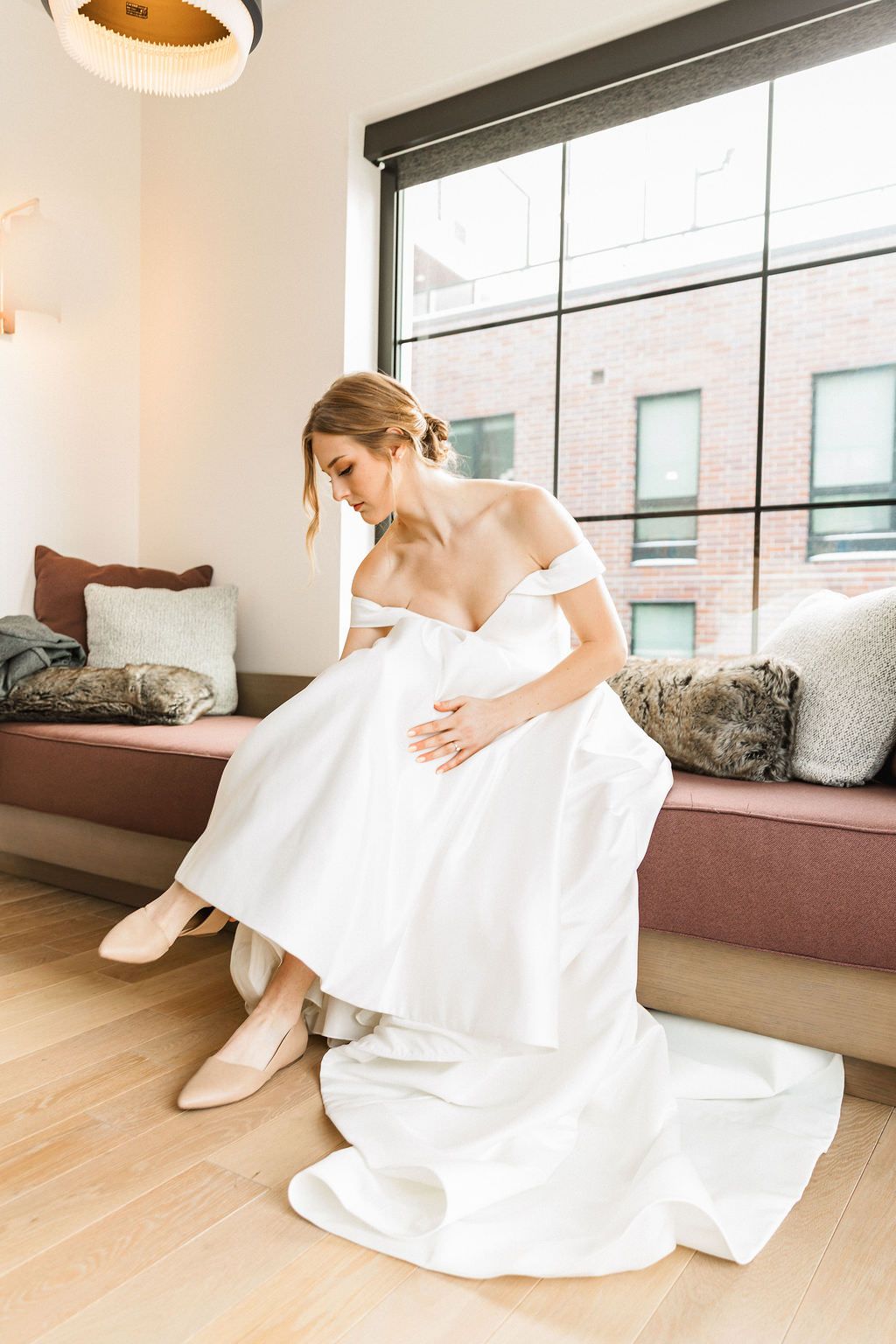 A tender motion sequence shows a person in a flowing white dress moving gracefully on a light wooden floor.