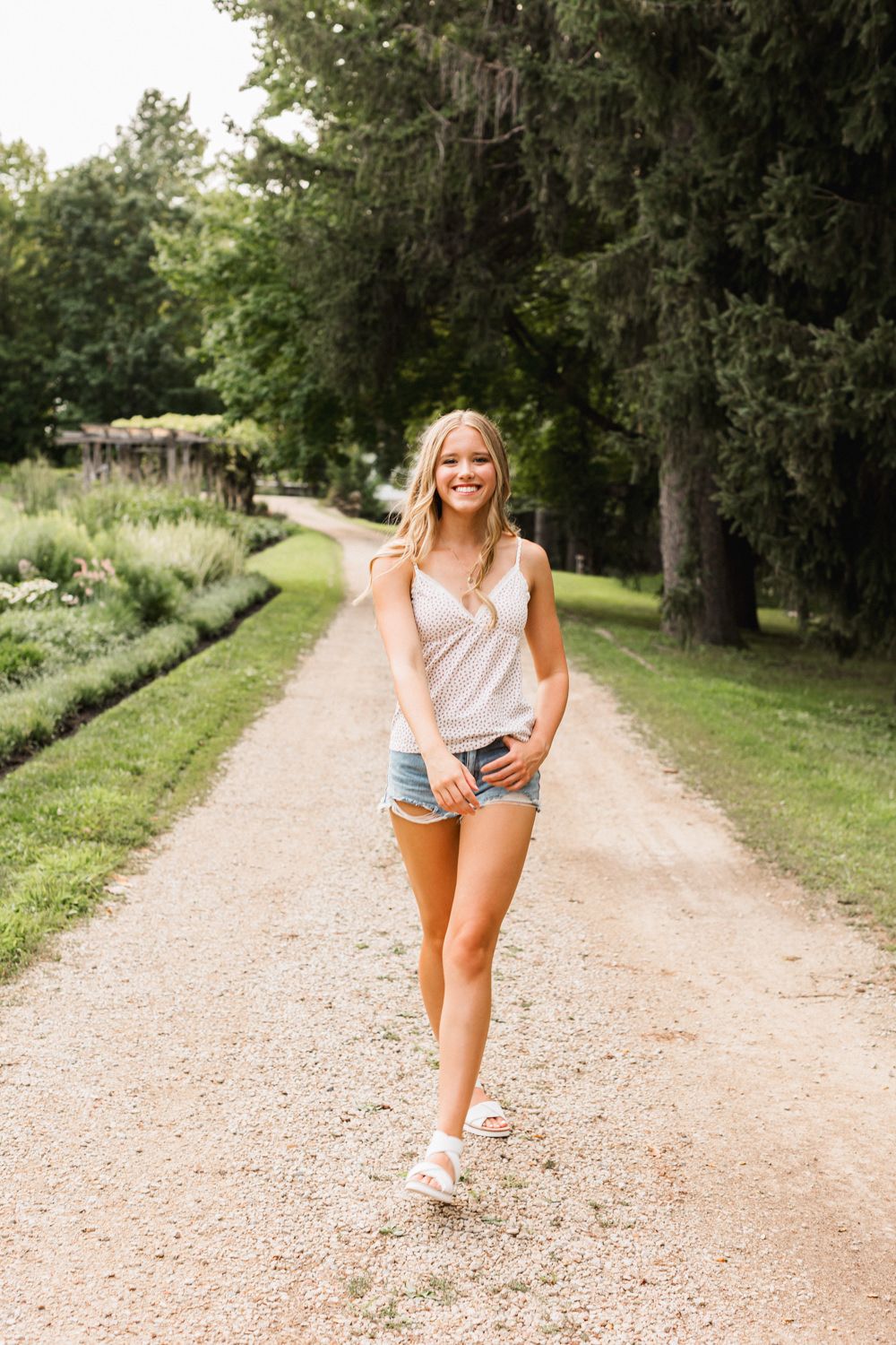 Casual lifestyle portraits on a gravel path surrounded by trees and greenery.