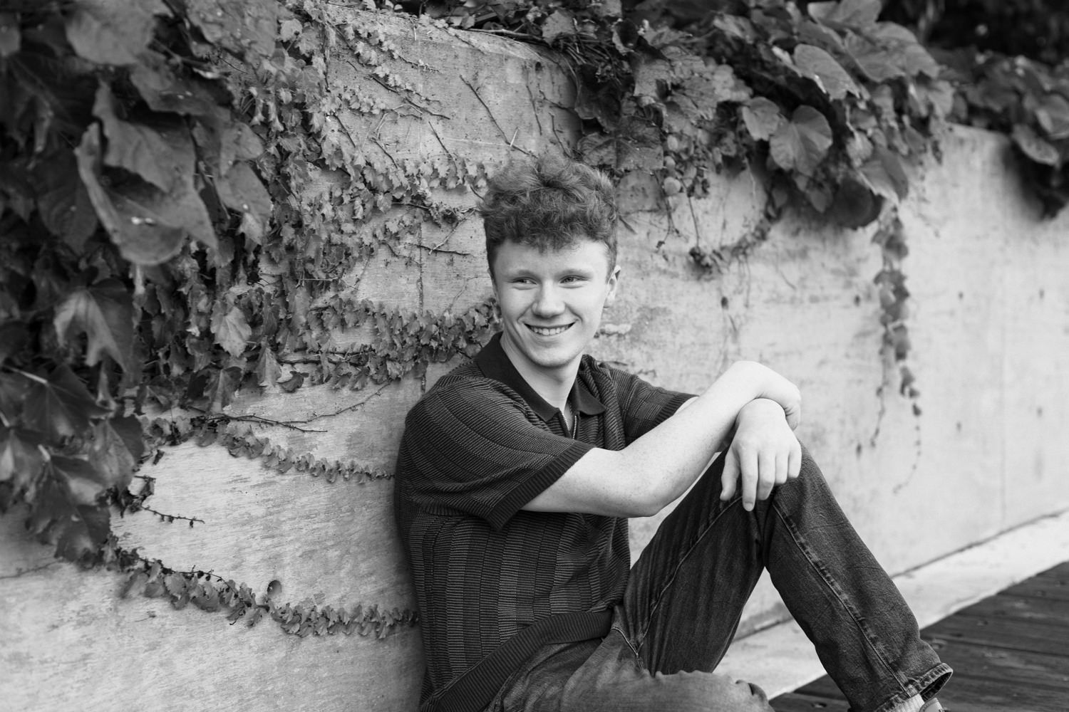 Black and white portrait series against textured wall with climbing foliage.