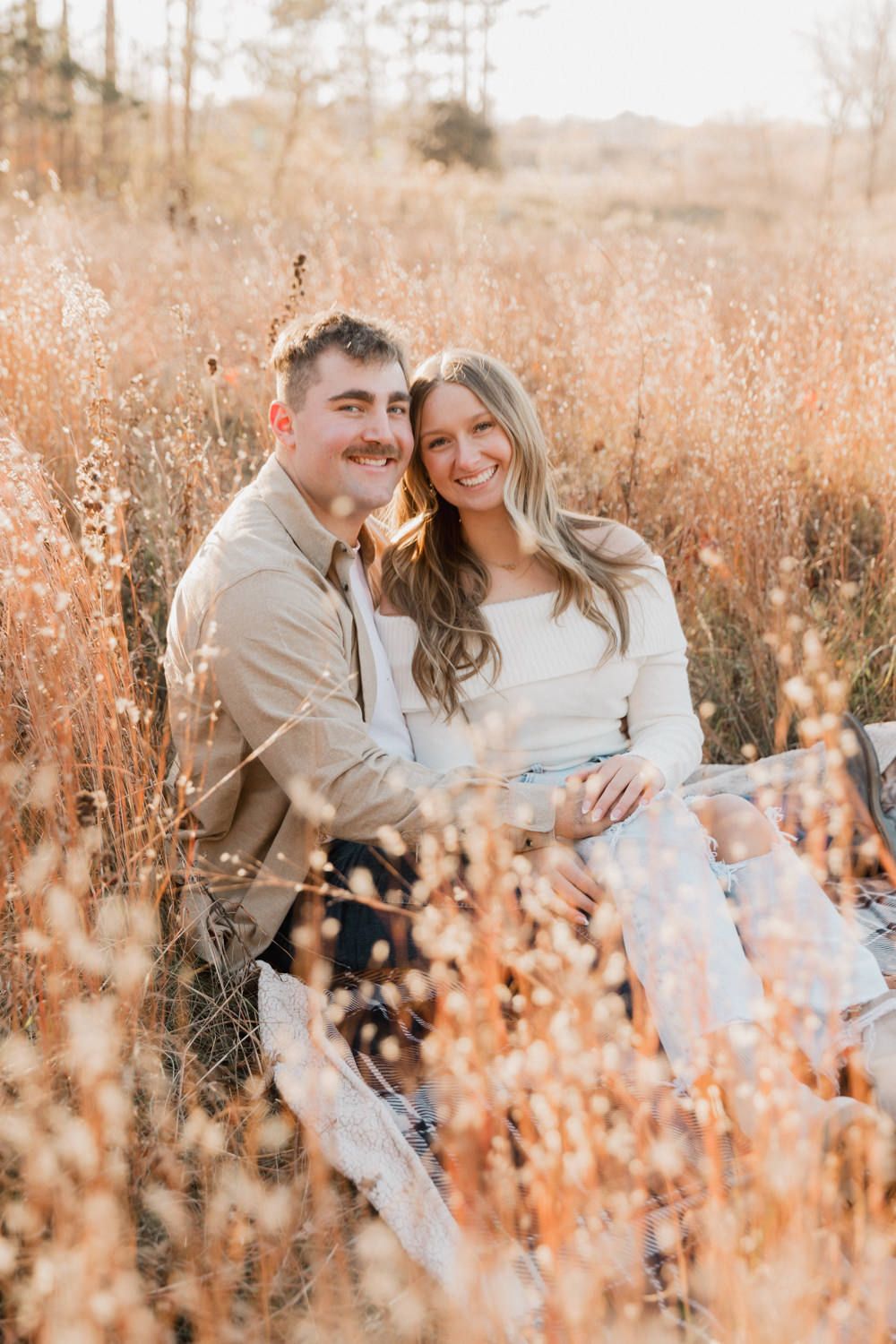 A joyful moment shared in a sun-drenched field of autumn grass.