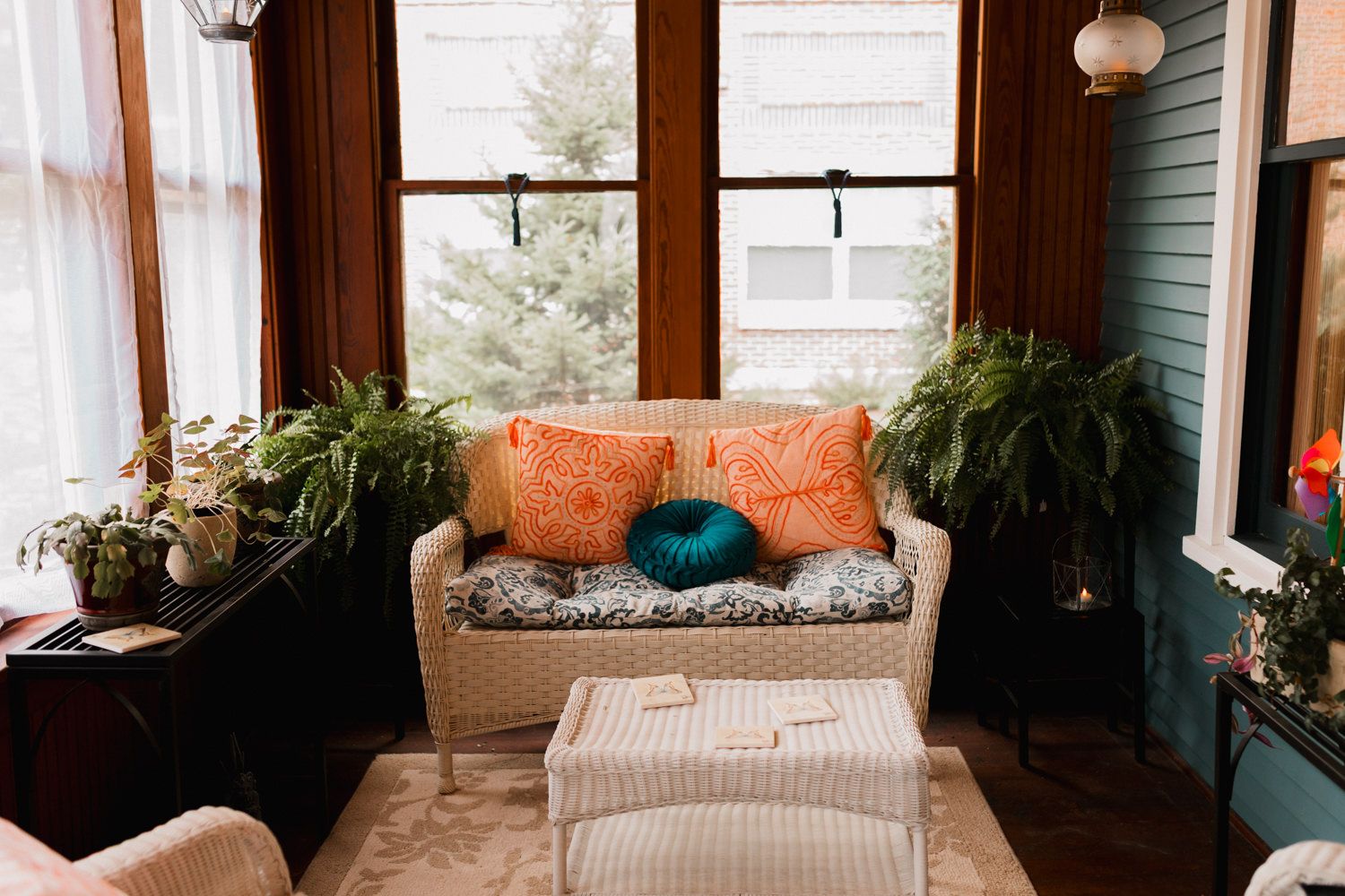 Cozy bohemian living room with natural light, houseplants, and warm wooden accents features a comfortable seating area.