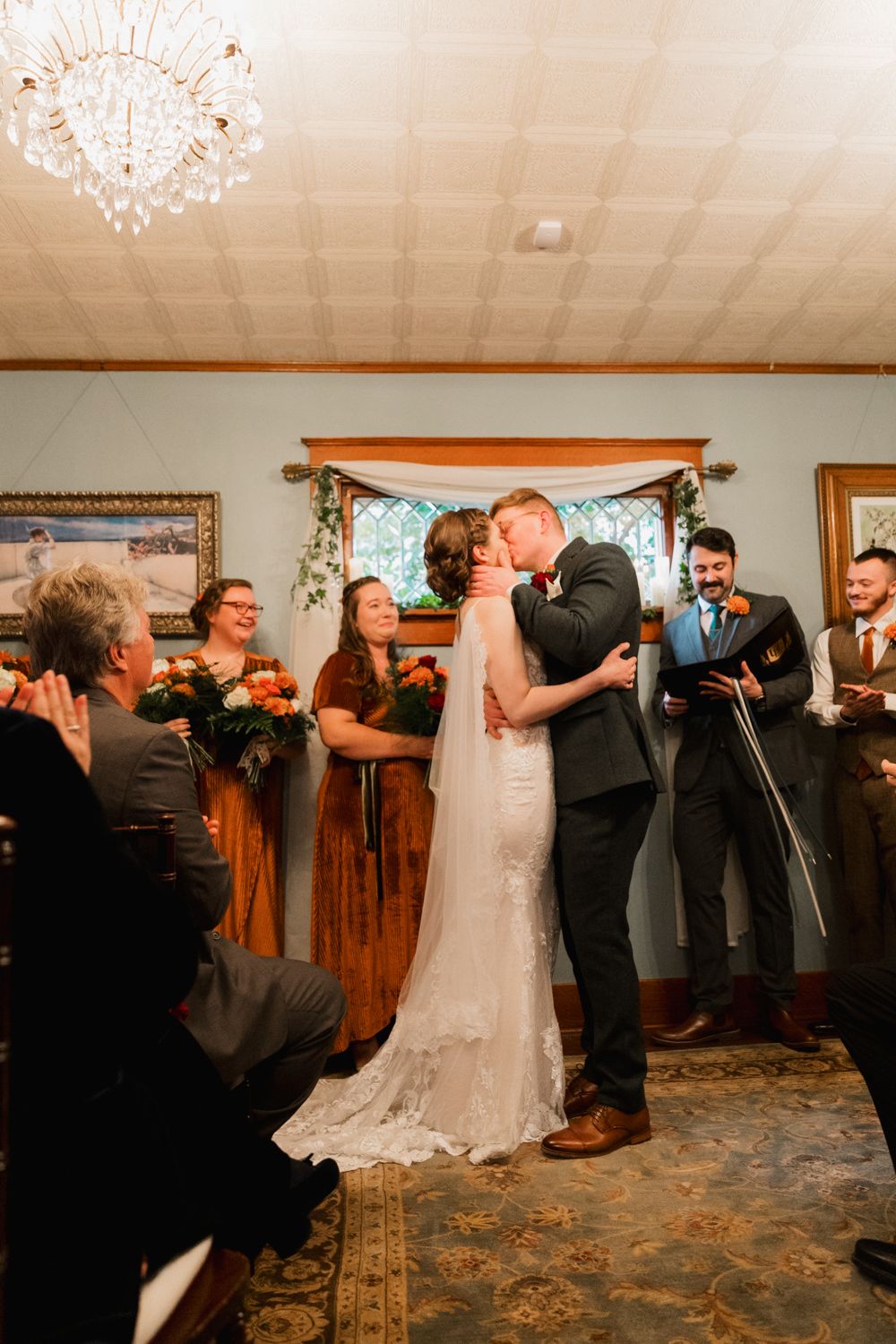 Wedding reception dance sequence showing couples twirling and dancing together in a rustic indoor venue.