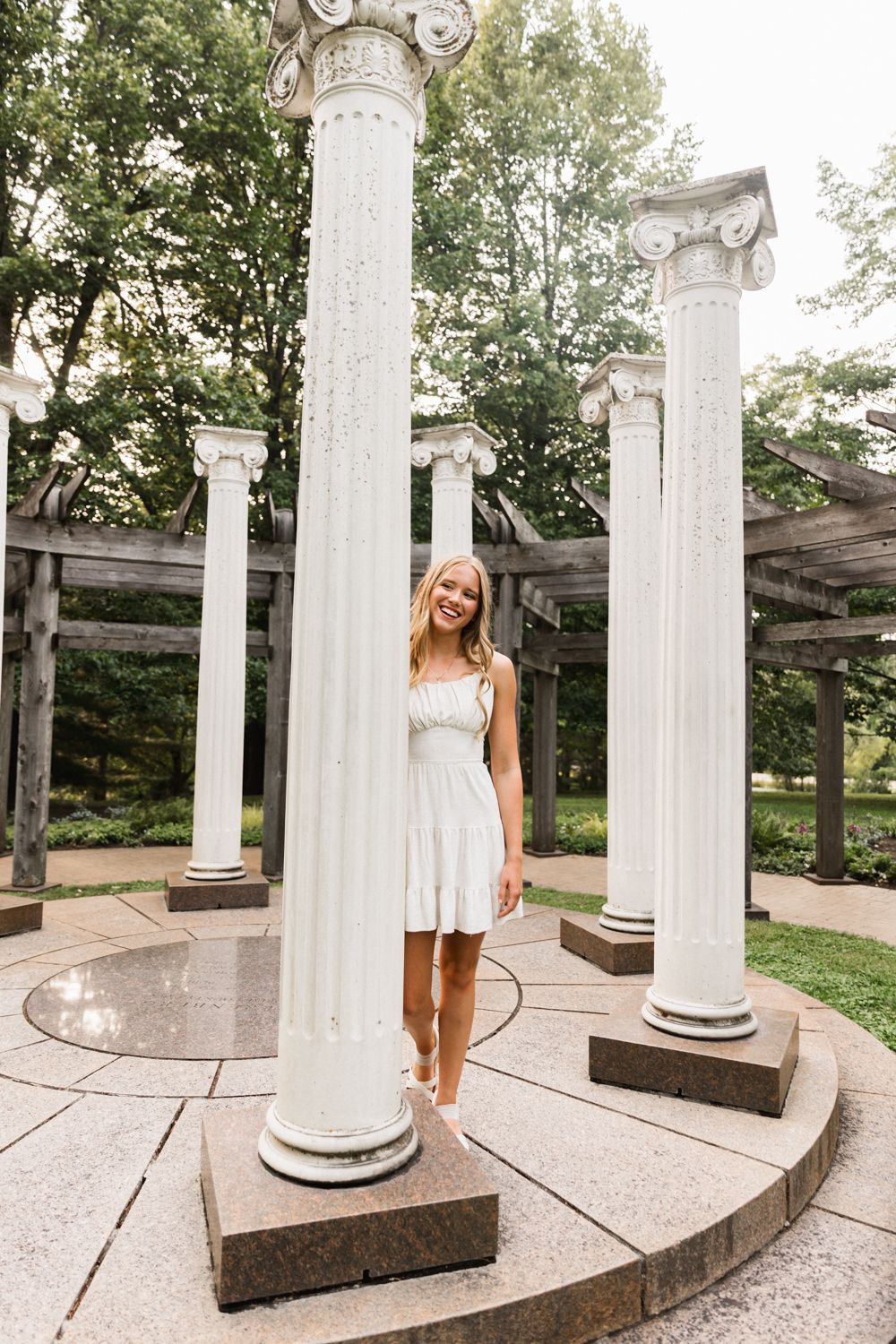 White architectural columns create a dramatic backdrop for outdoor portraits.
