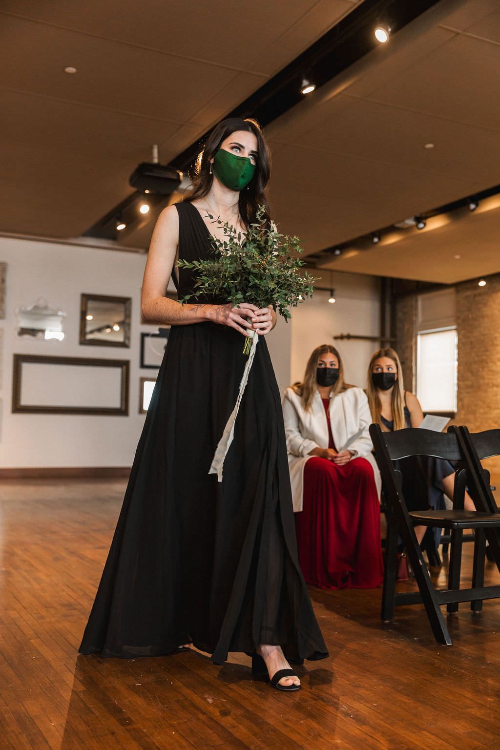 Reception venue with warm lighting features wooden floors and exposed brick walls.
