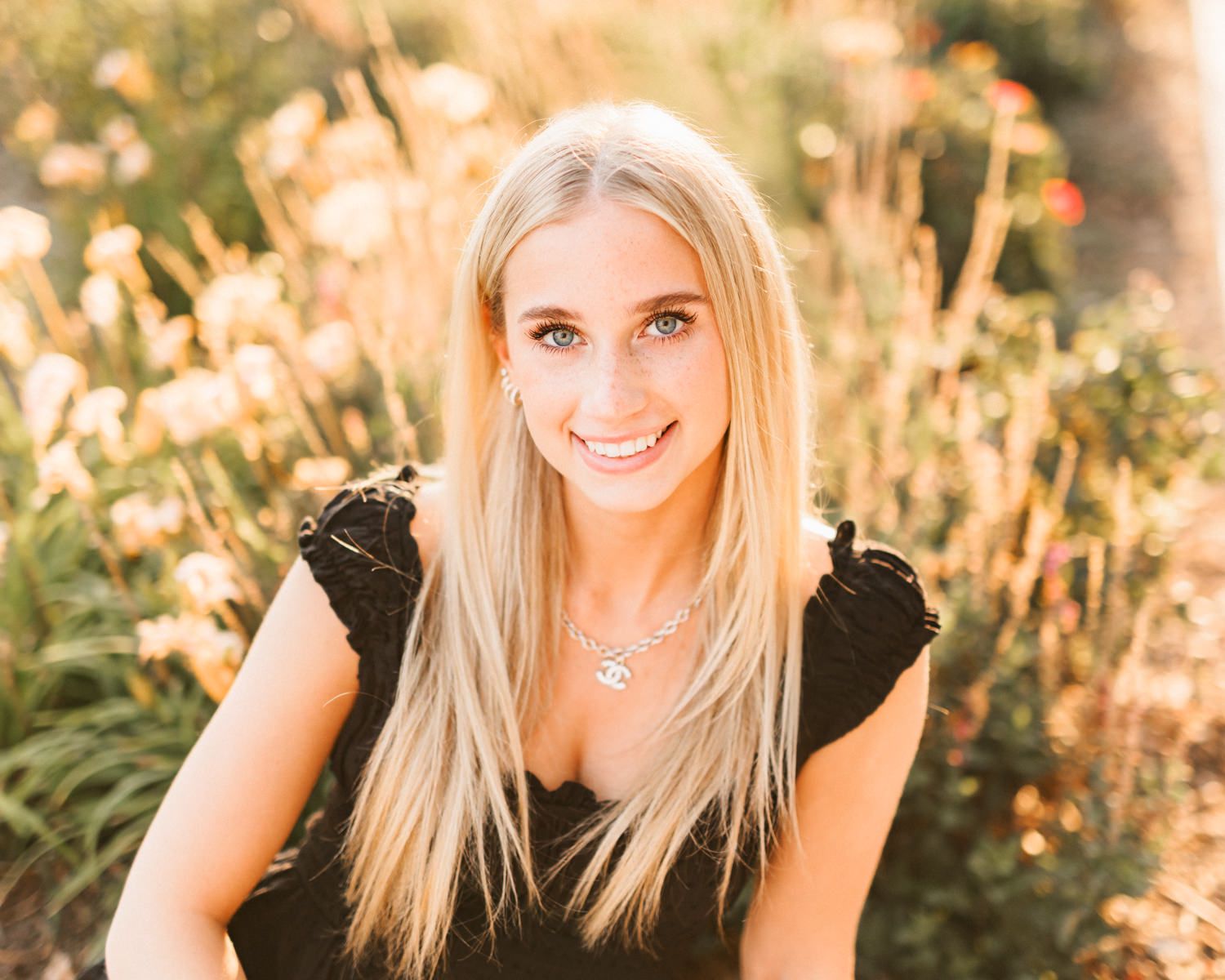 Outdoor portrait with golden sunset lighting and natural background.