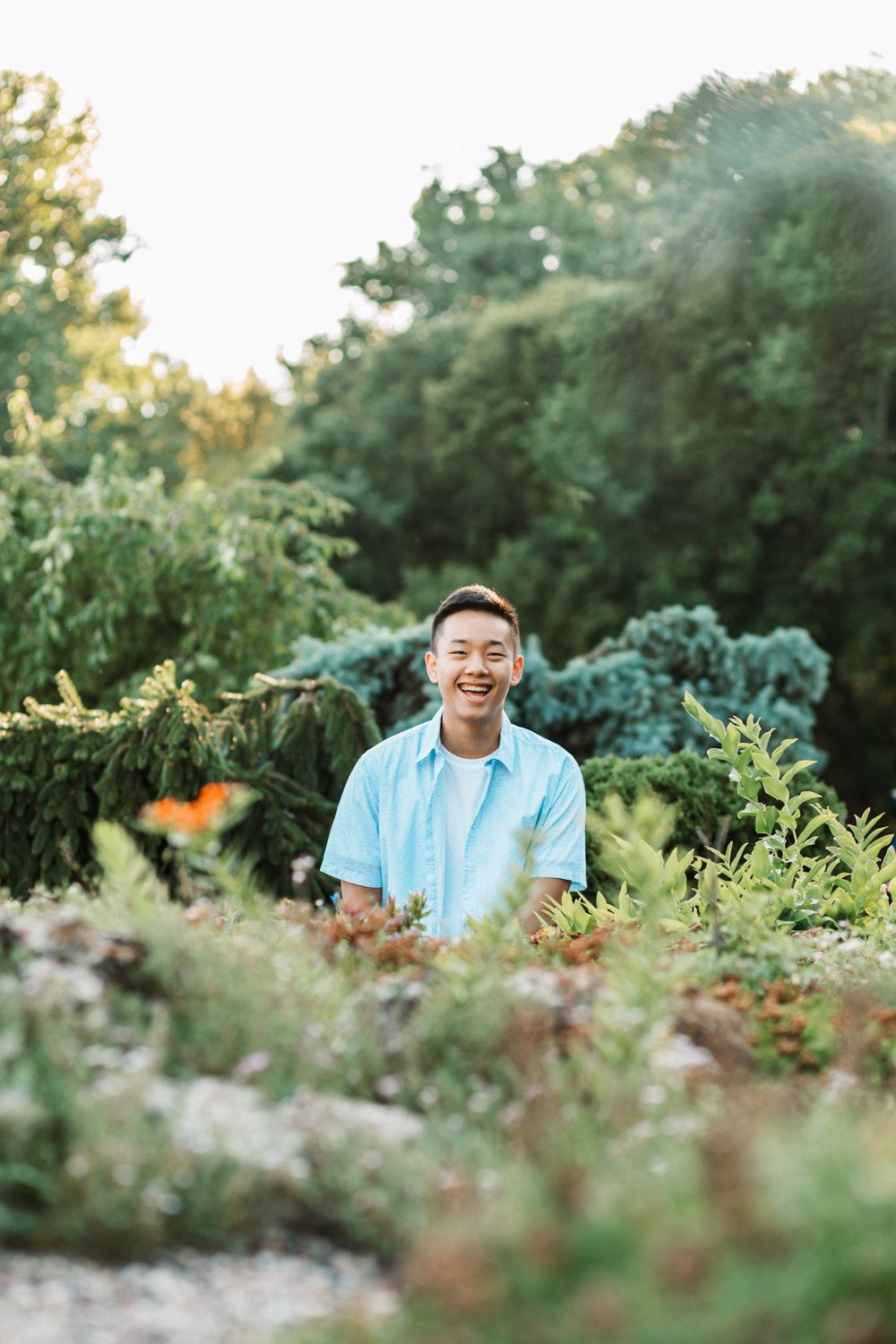 Summer portrait in a lush garden setting with soft natural lighting.