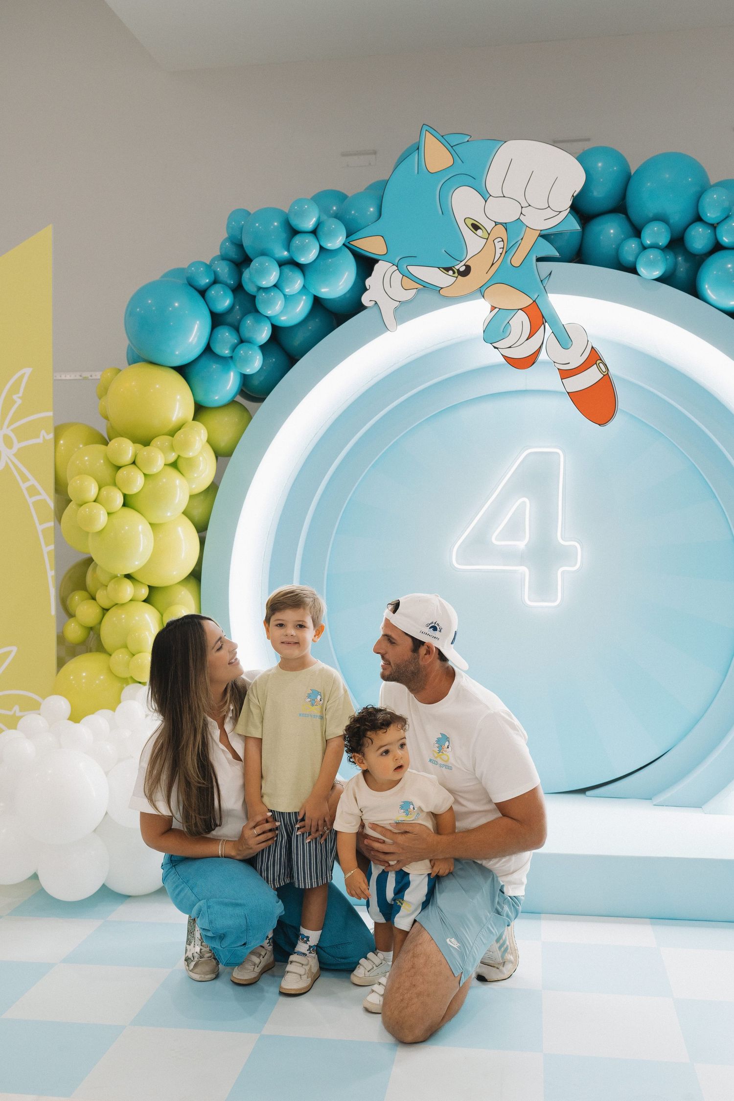 Sonic-themed birthday party backdrop with blue and yellow balloon garlands and the number 4.