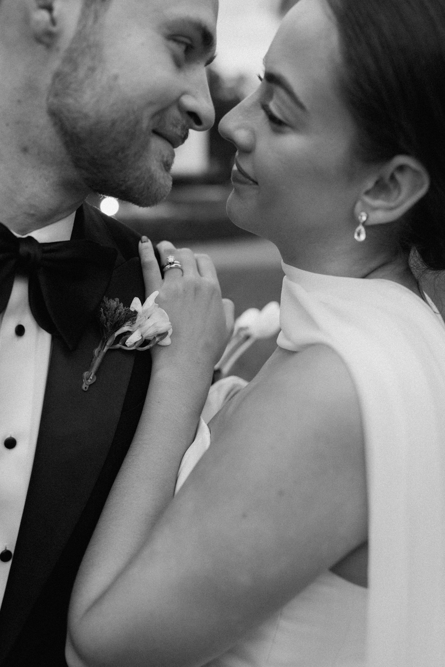 Intimate black and white portrait of newlyweds sharing a romantic moment.