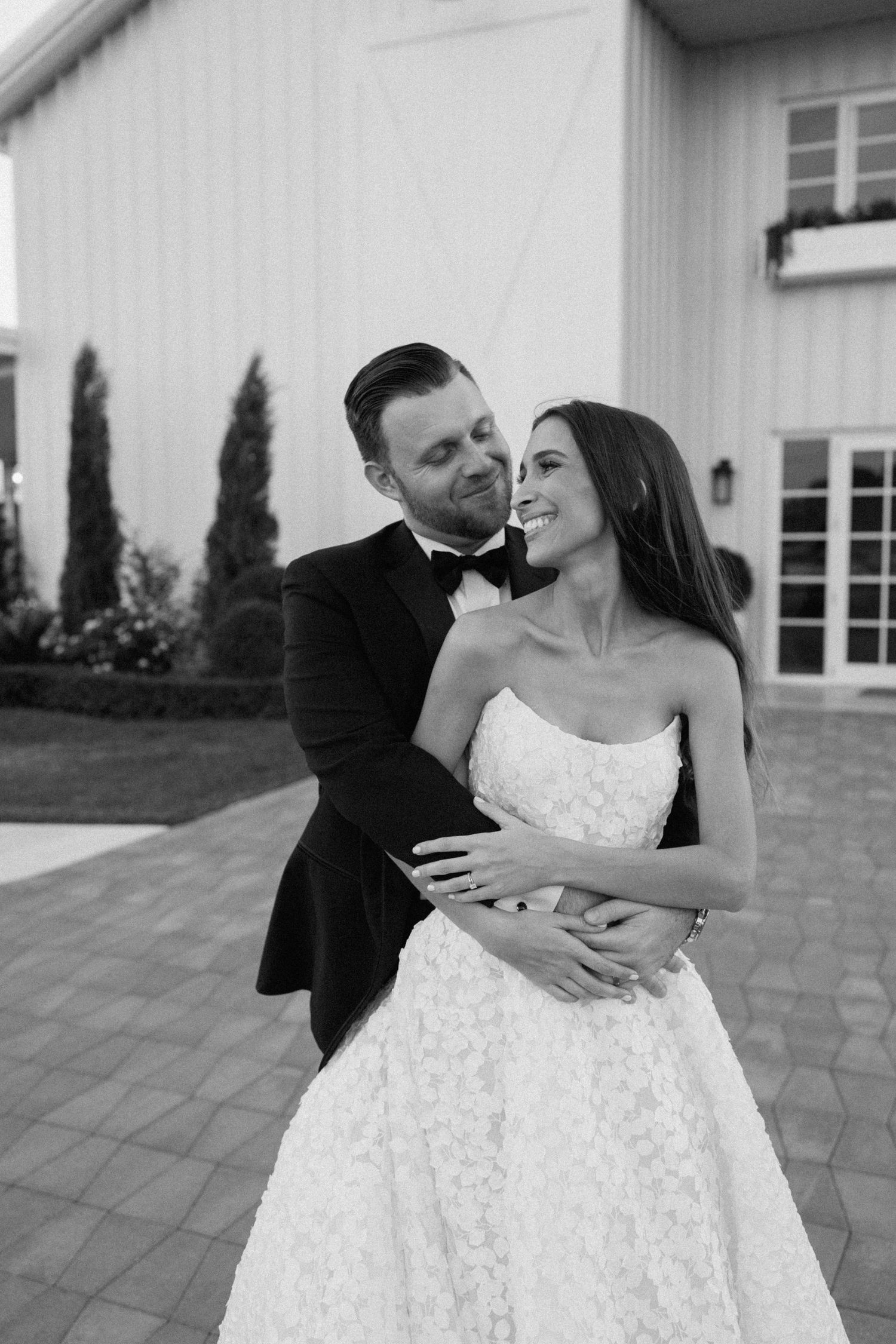 A couple shares a romantic dance moment on an outdoor patio.