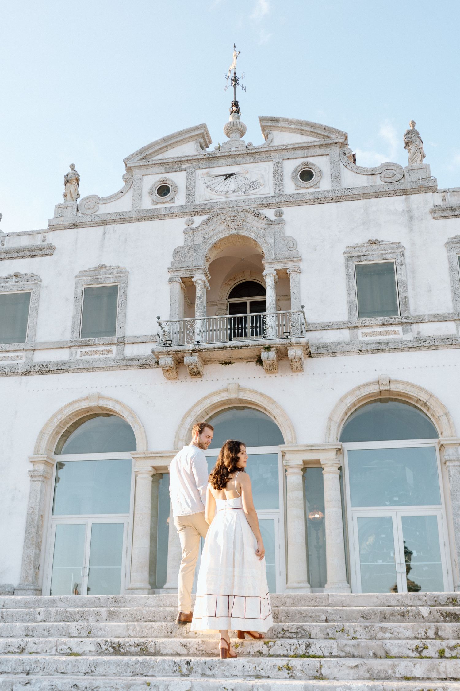 A stunning white Mediterranean-style building with classic arches and ornate architectural details.