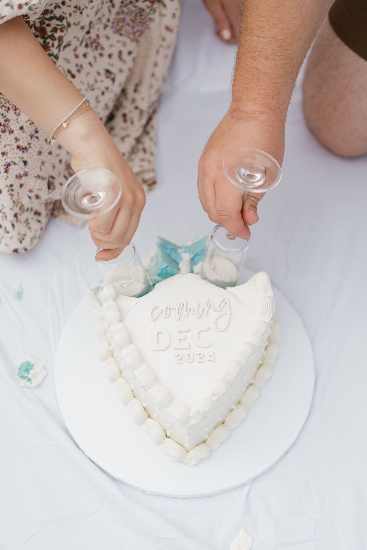 Close-up of hands making baby footprints in white clay or plaster.