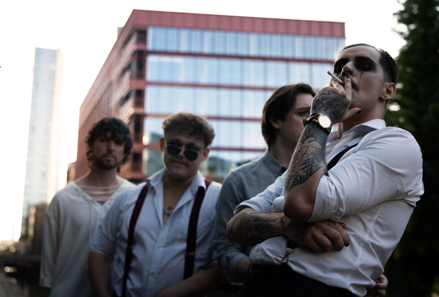 The four members of Macclesfield/Manchester band Von. the singer, Oskar, is smoking a cigarette and looking down at the camera.