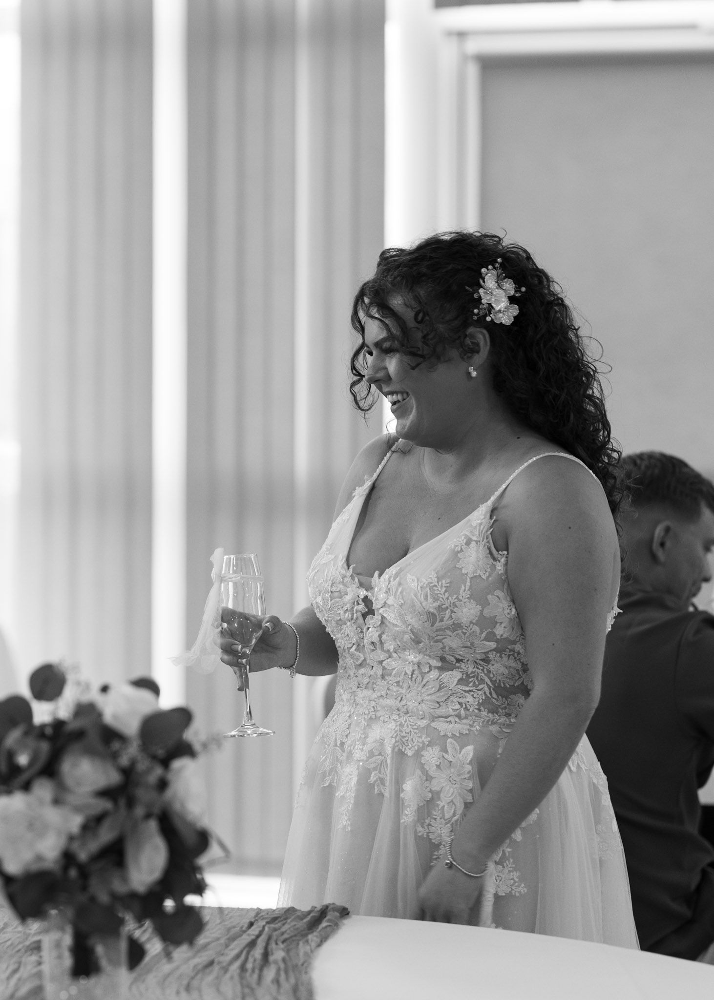 Wedding reception scene with elegant white decor and floral arrangements.