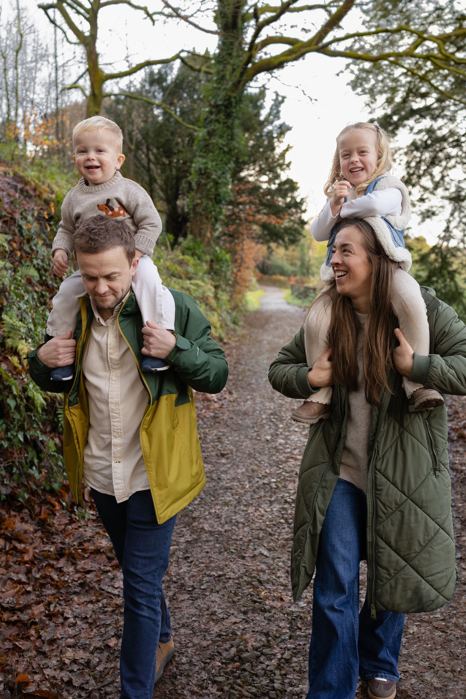A playful sequence of candid moments in a wooded path during autumn with joyful interaction and laughter.