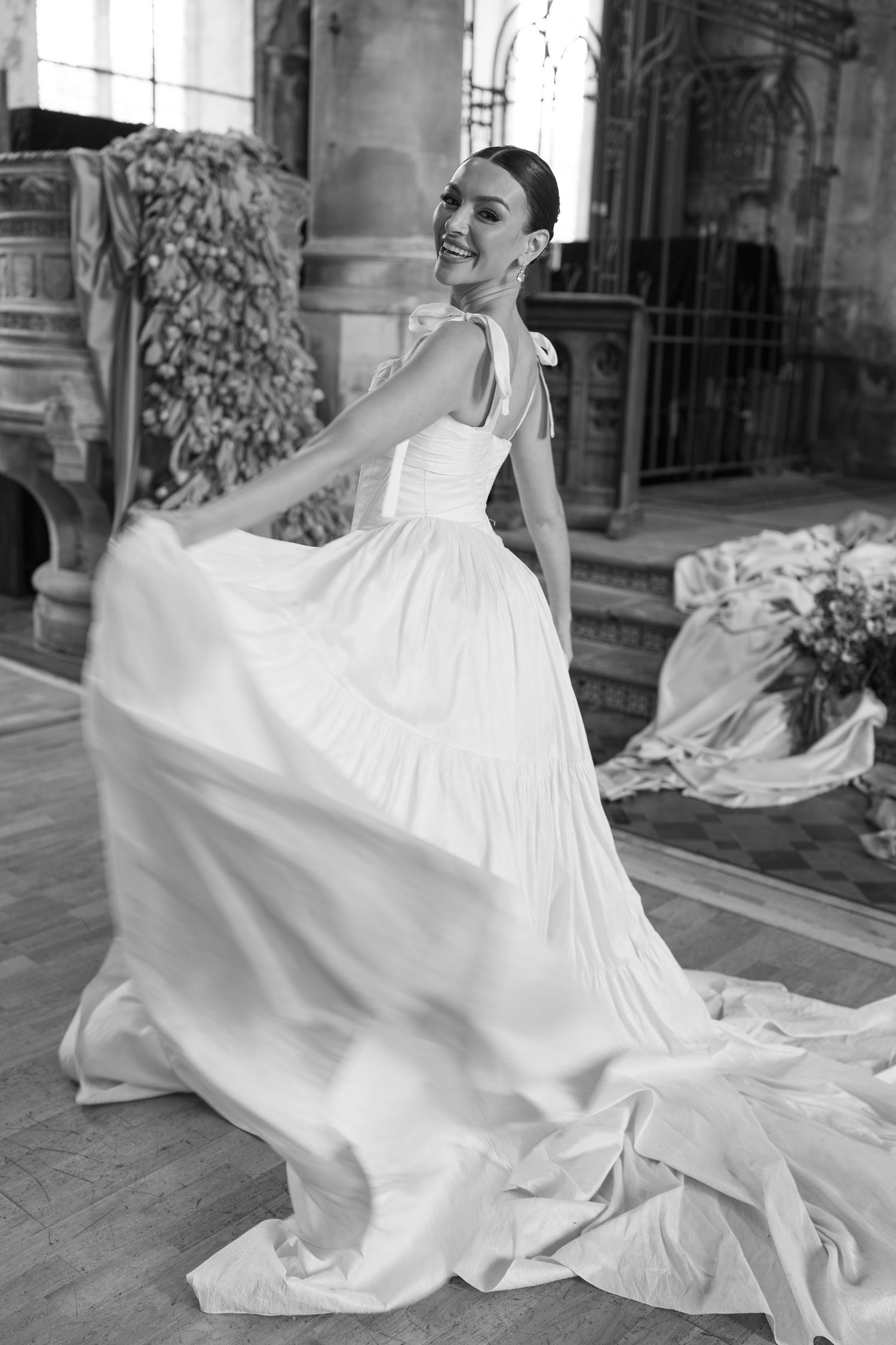A flowing white wedding dress billows dramatically in a series of artistic black and white photographs.