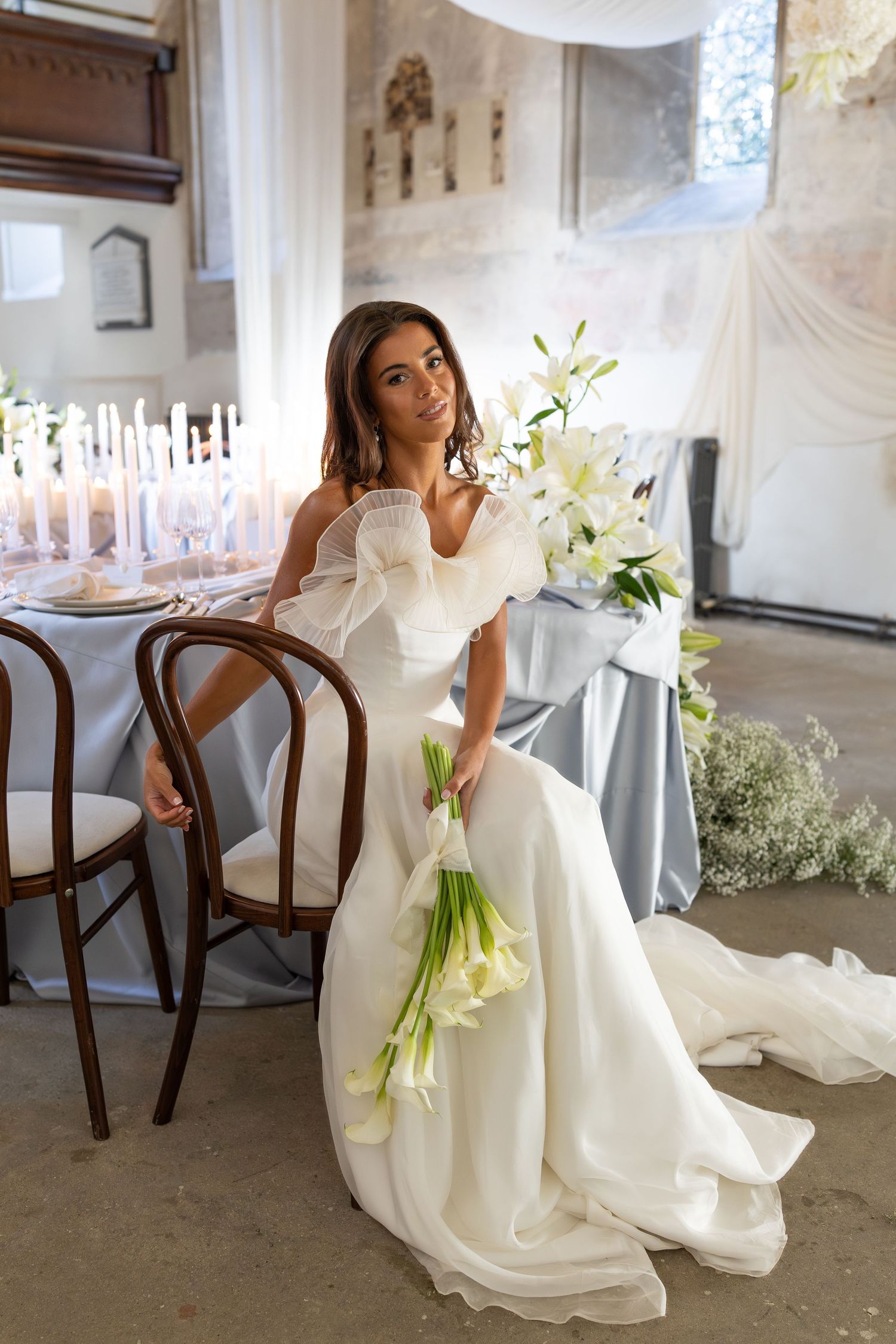 Elegant bridal portraits featuring a white gown and calla lily bouquet in a vintage interior setting.