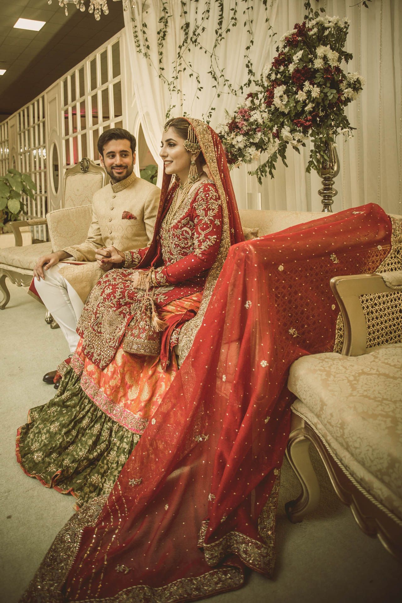 Bride and groom sharing a romantic moment at a luxury wedding venue in Karachi, captured with traditional elegance.