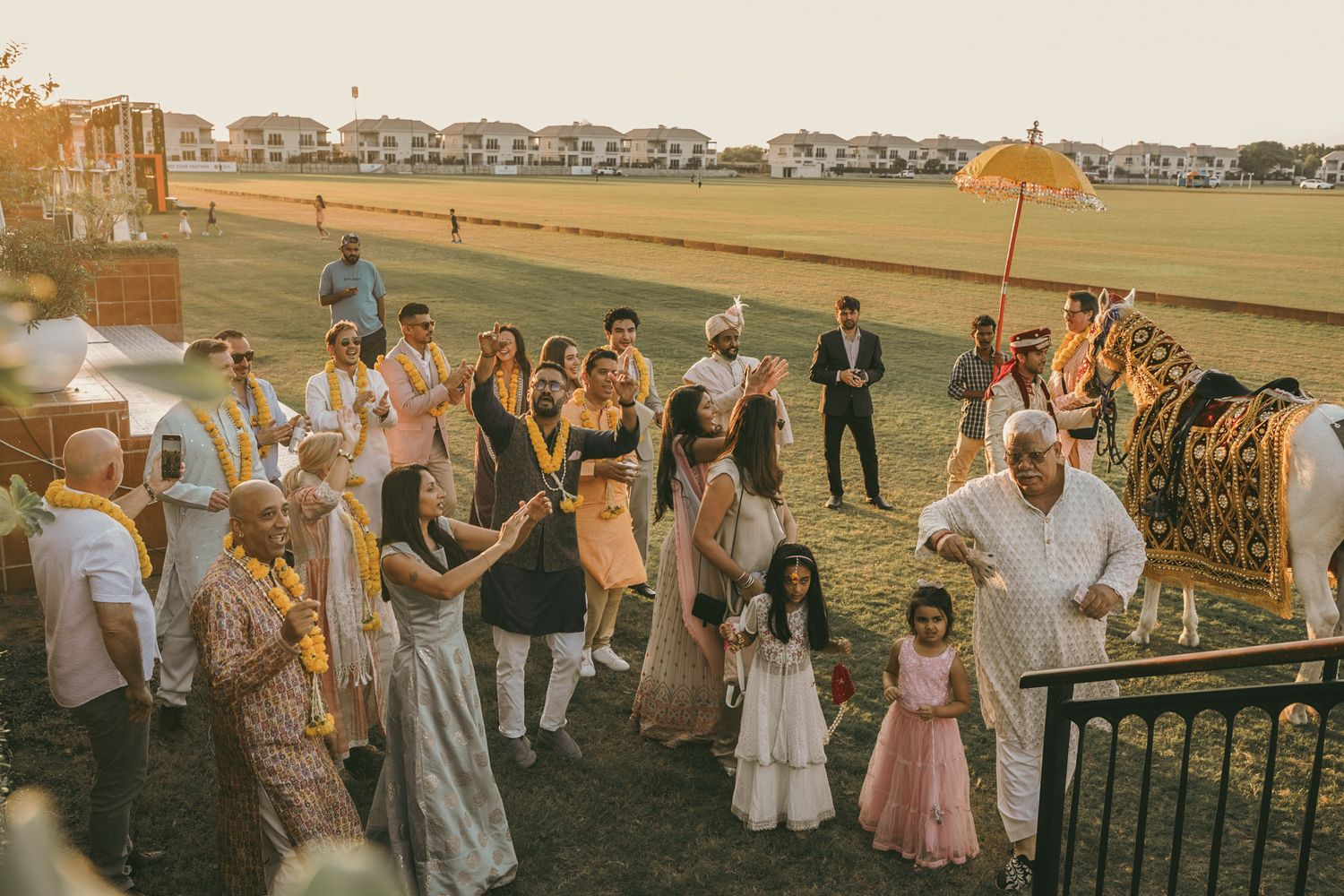 Heartfelt moment captured: aunt adjusting bride's jhumka before the stage walk, reflecting the deep love and tradition of South Asian weddin