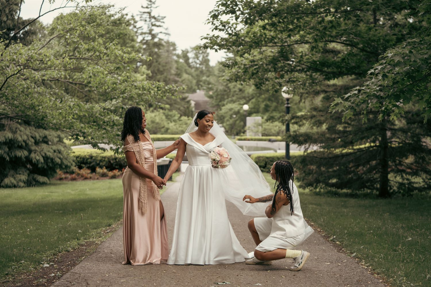 Bride mates fixing brides outfit during the couple photoshoot at the heart of Ottawa
