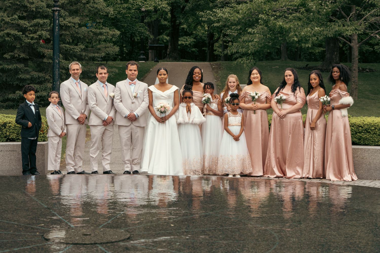Heartfelt moment captured: bride and groom siblings, reflecting the deep love and tradition of white weddings in one group photo.
