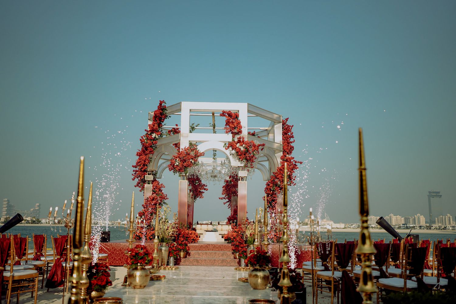 dripping orchids and soft pastel tones in the mandap stage designed to elevate the ambiance of a high-end multicultural wedding celebration.