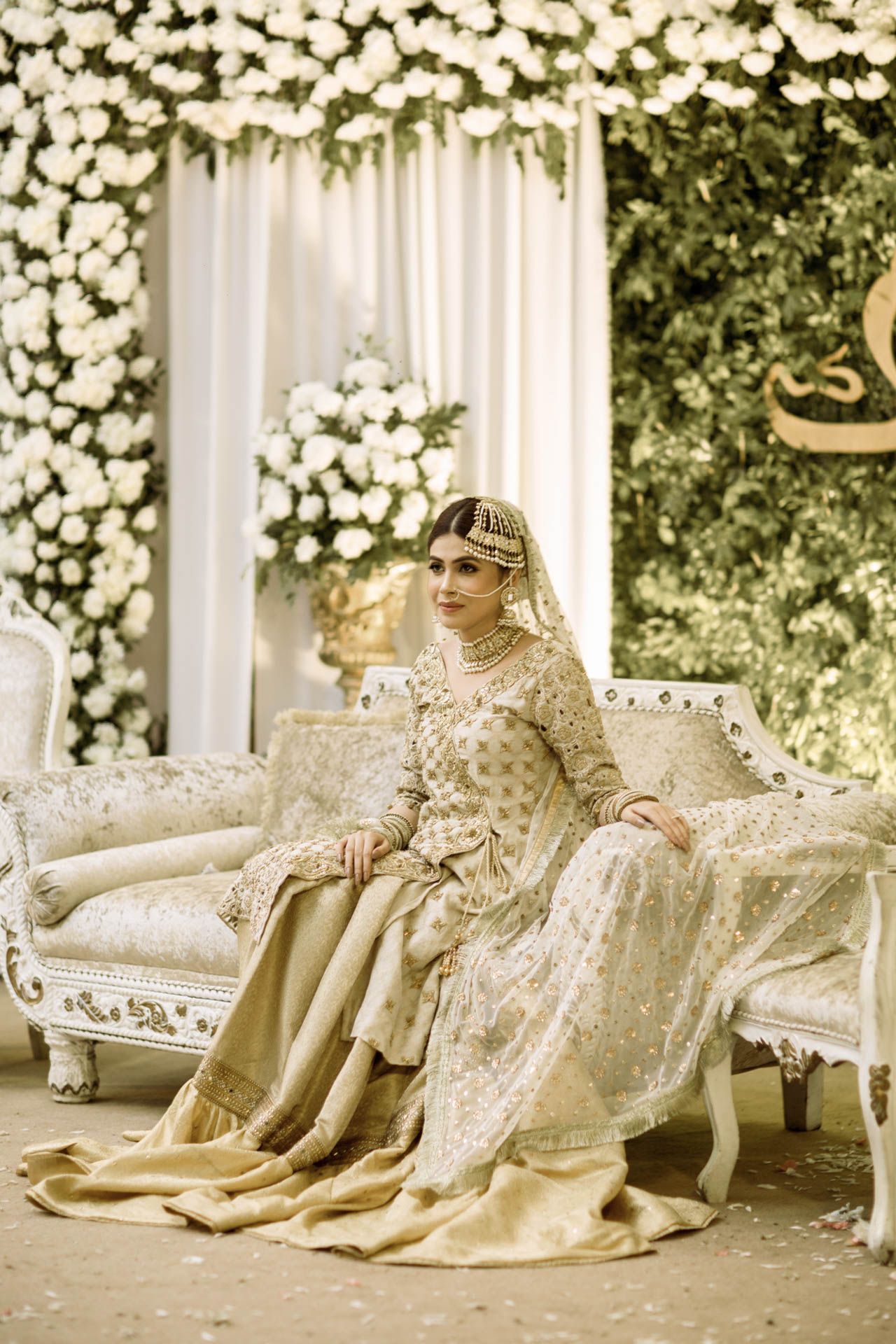 Bridal portrait in a Dubai luxury suite showcasing traditional attire blended with contemporary elegance.