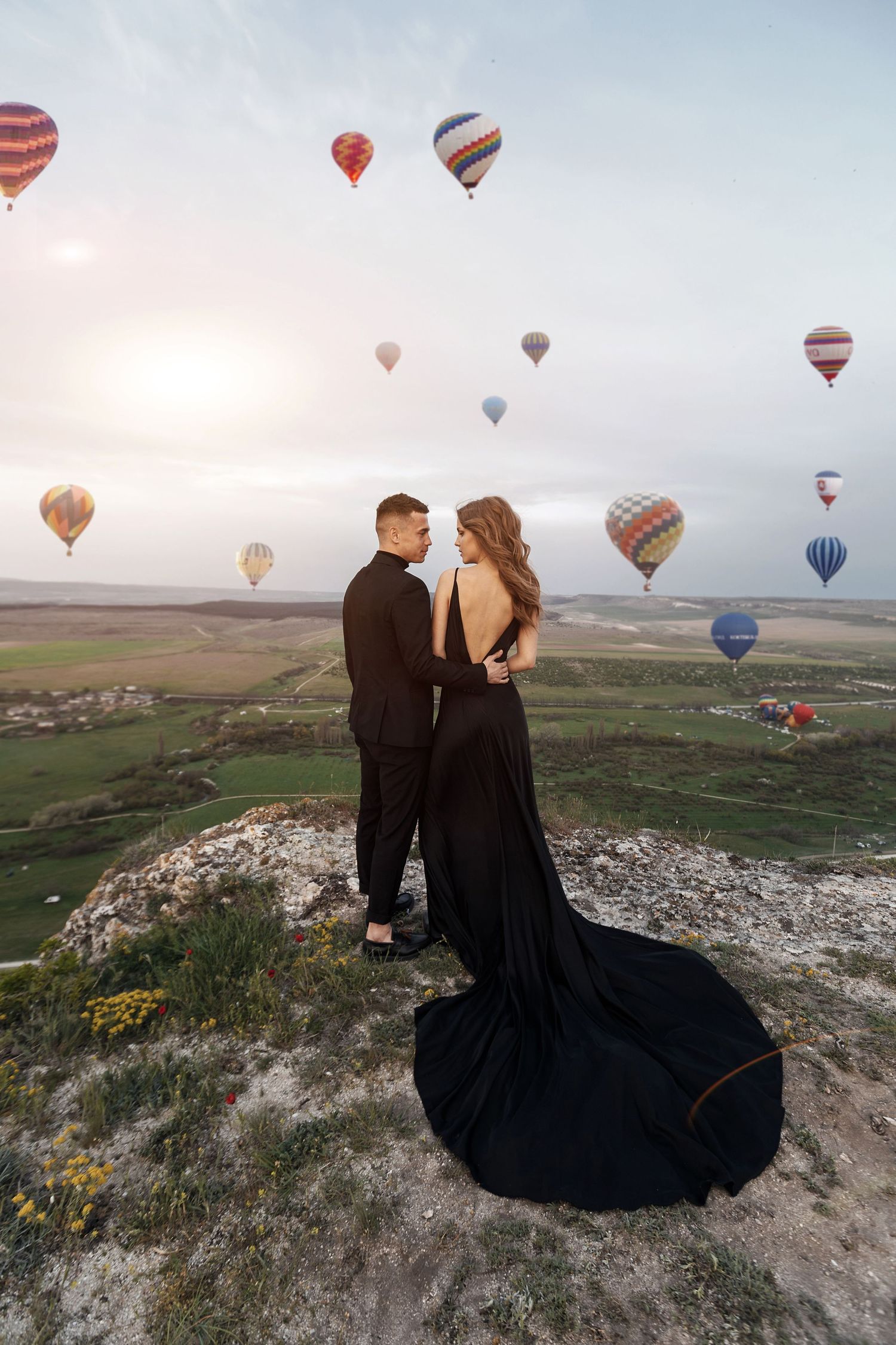 Epic mountain engagement portrait in Cappadocia, with the bride’s veil flowing in the breeze.