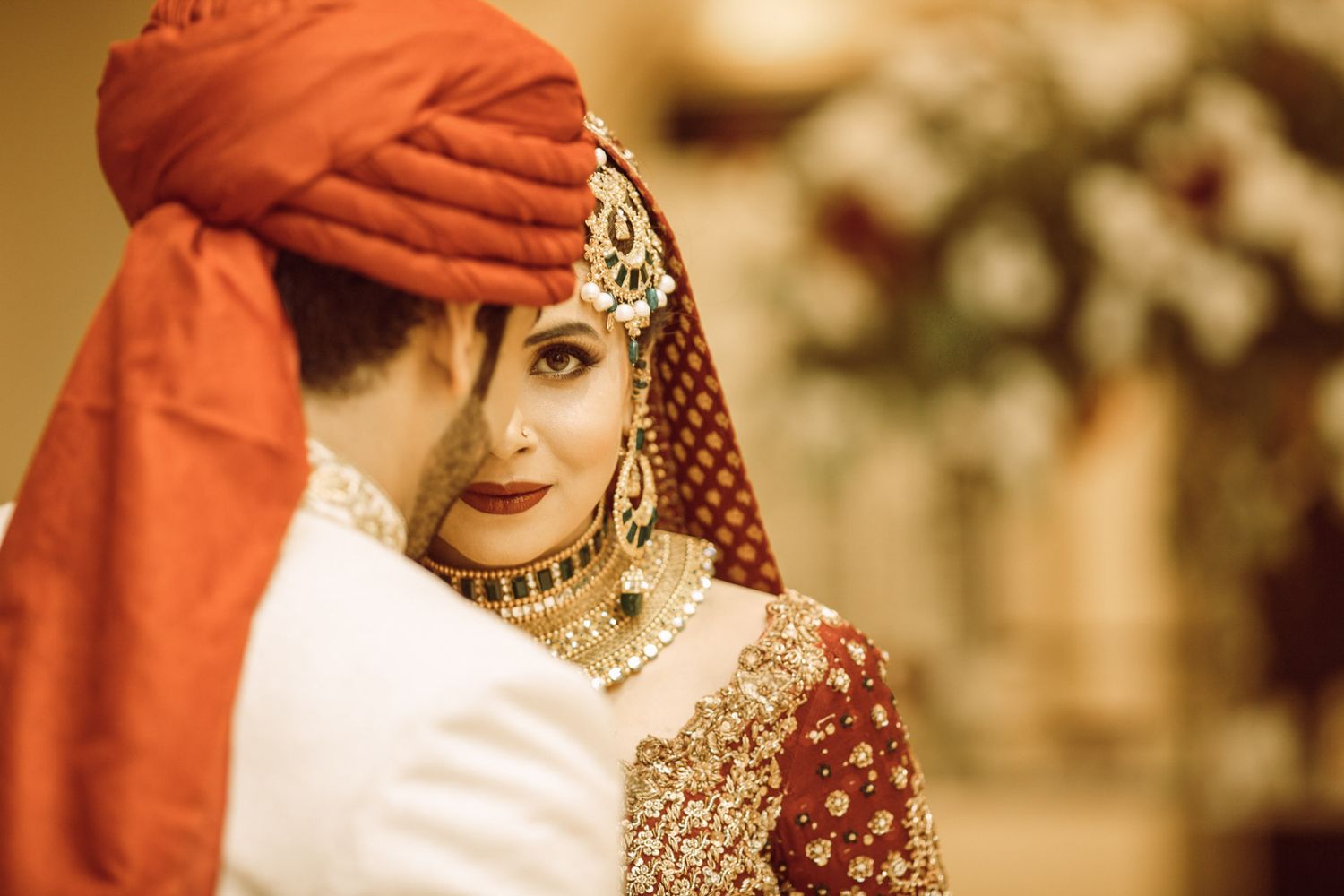 Stylish Pakistani couple in coordinated pastel outfits posing for a modern wedding shoot in Islamabad.