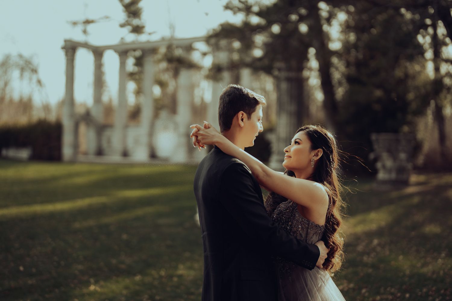 Romantic moment during an engagement session at Guild Inn Estate, Toronto, with soft sunlight filtering through heritage trees.