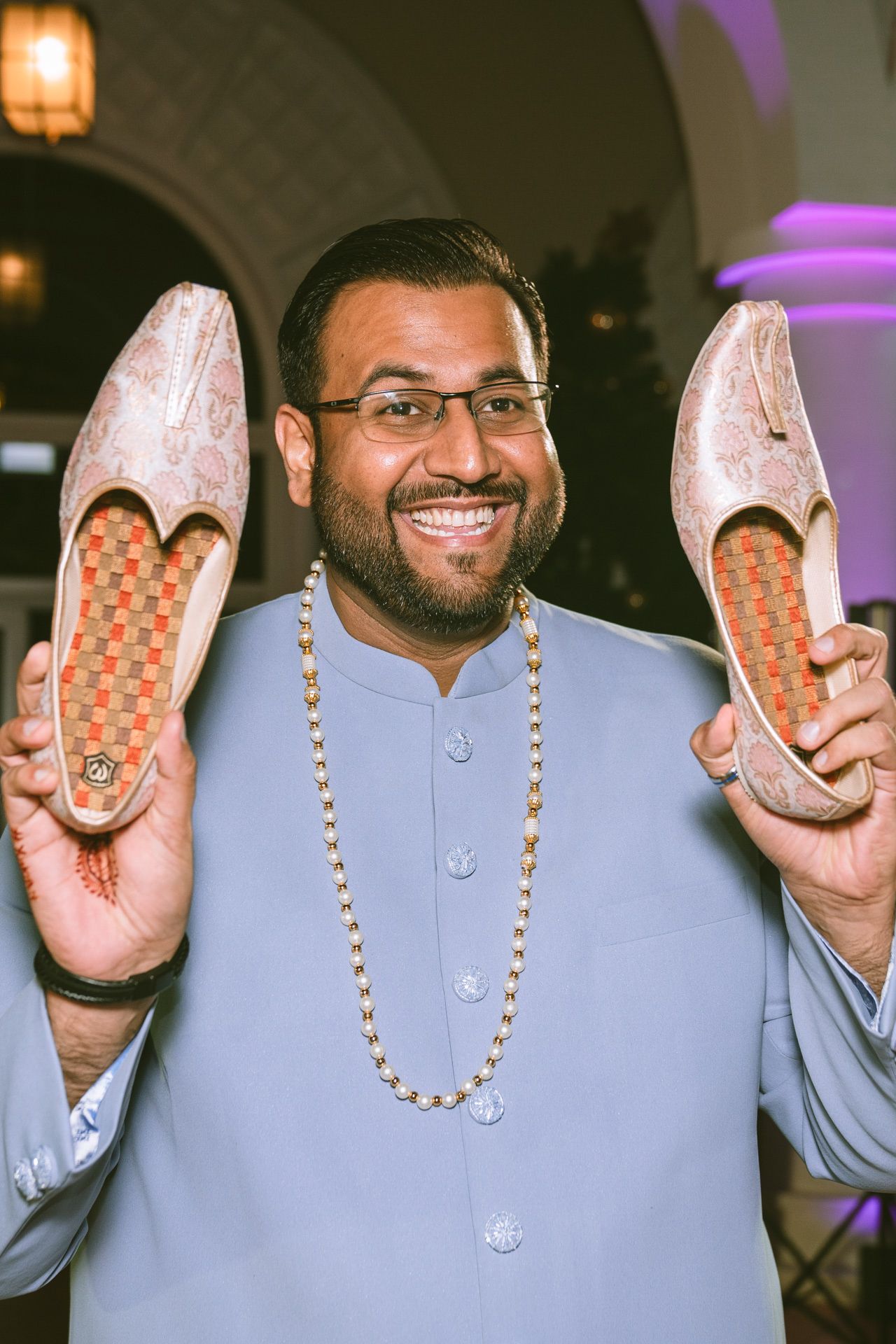 Cousins having fun with shoe hidding the groom after the ring ceremony, indian weddings