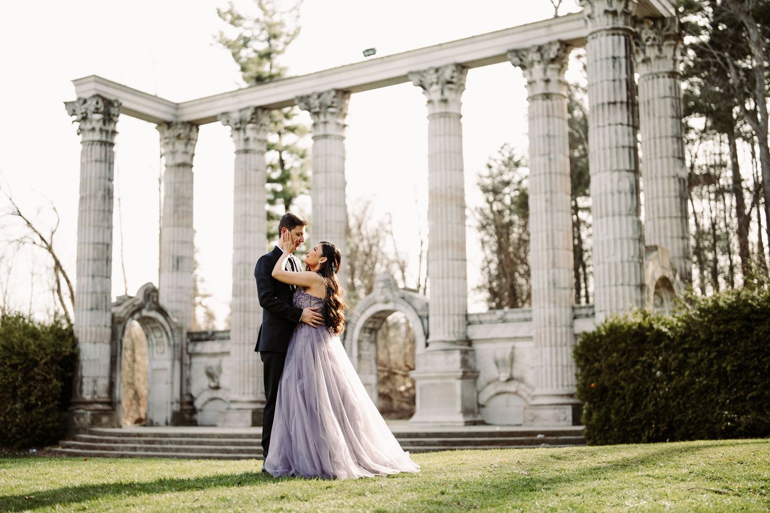 Modern couple embracing under the stone archways of Guild Inn Estate, a top location for Toronto engagement photography.