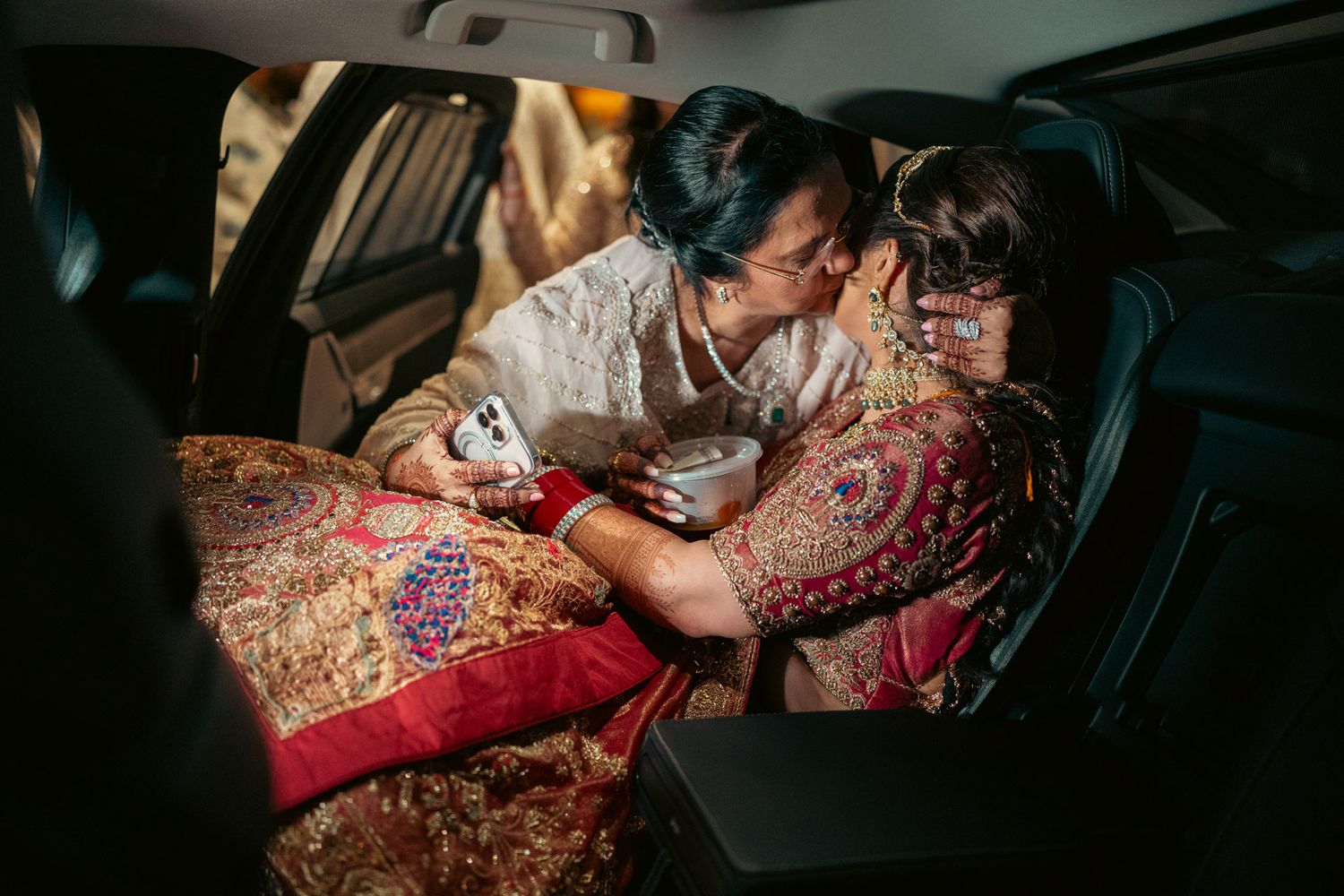 Heartfelt moment captured: father kissing bride’s forehead during rukhsati, reflecting the deep love and tradition of South Asian weddings.