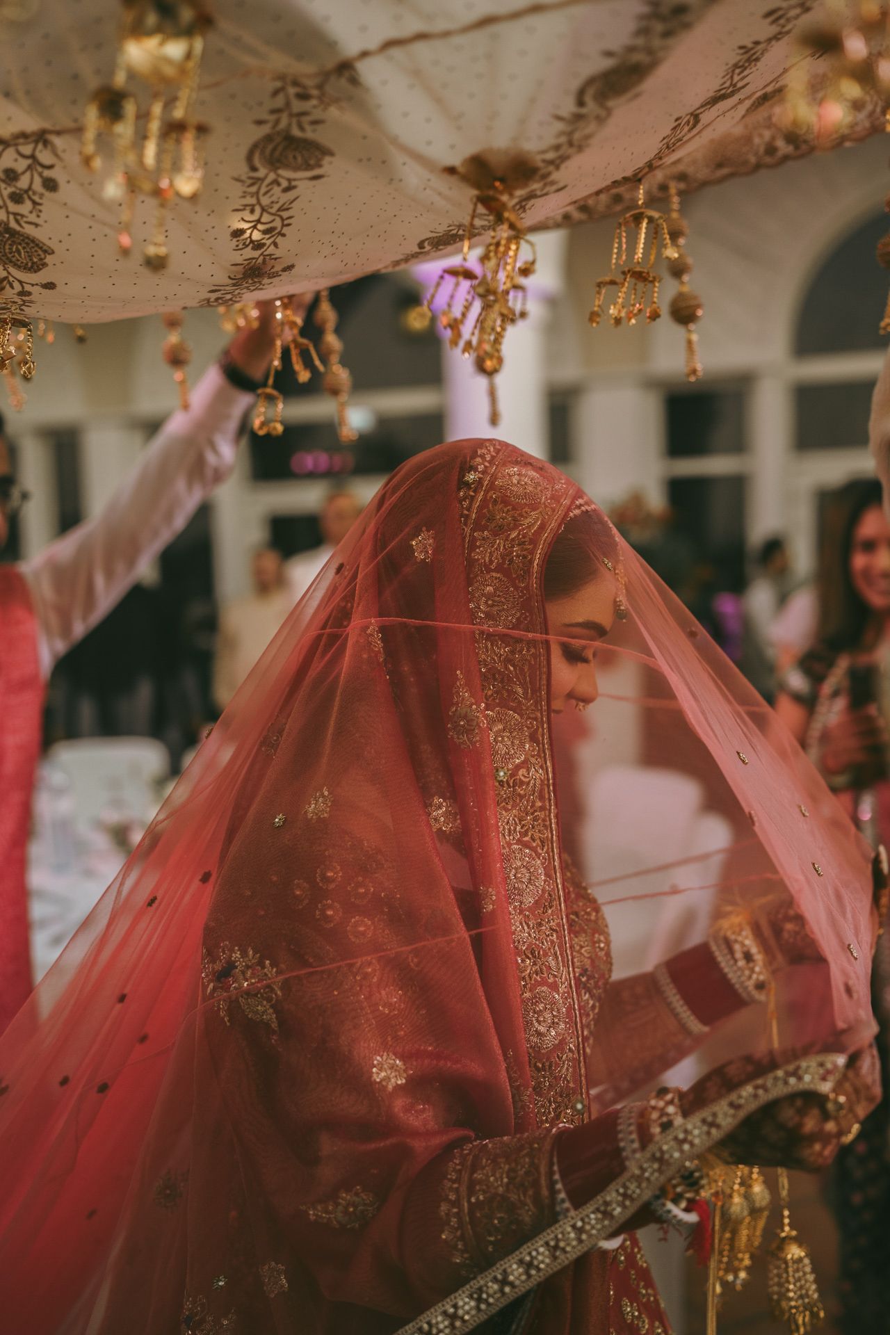 Heartfelt moment captured: father kissing bride’s forehead during rukhsati, reflecting the deep love and tradition of South Asian weddings.