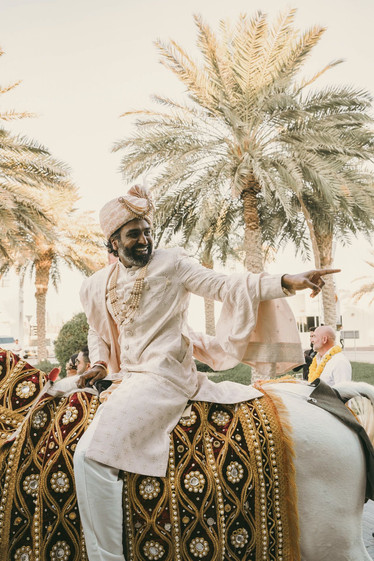 Heartfelt moment captured: grandfather holding groom's hand proudly, reflecting the deep love and tradition of South Asian weddings.