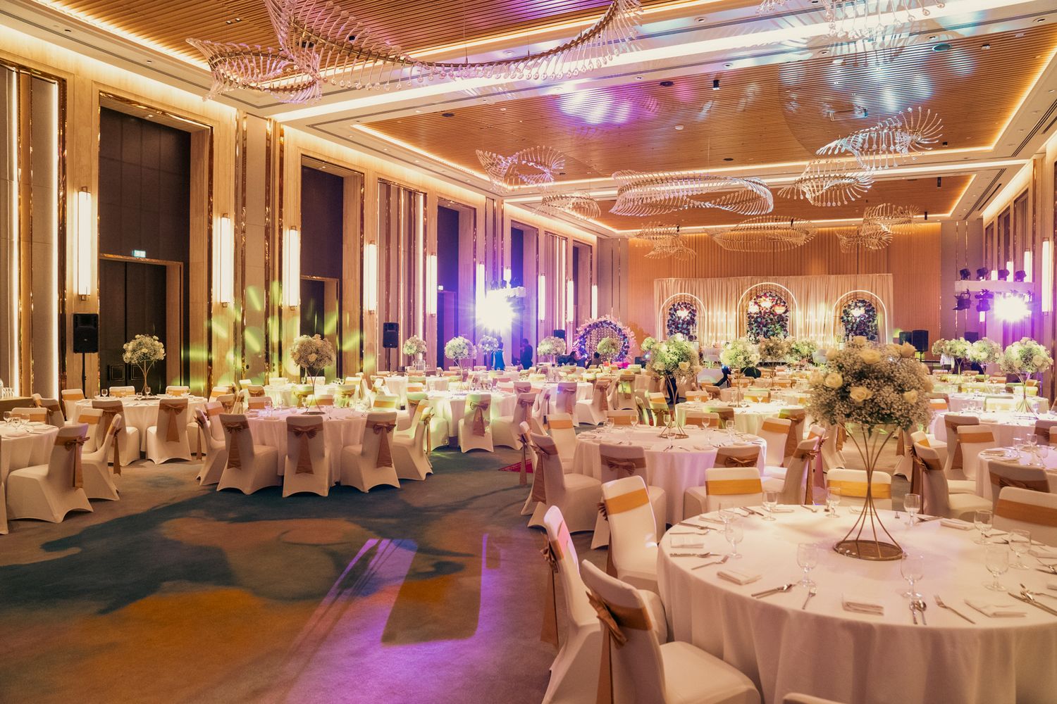 elegant mirror table with floating candles designed to elevate the ambiance of a high-end multicultural wedding celebration.