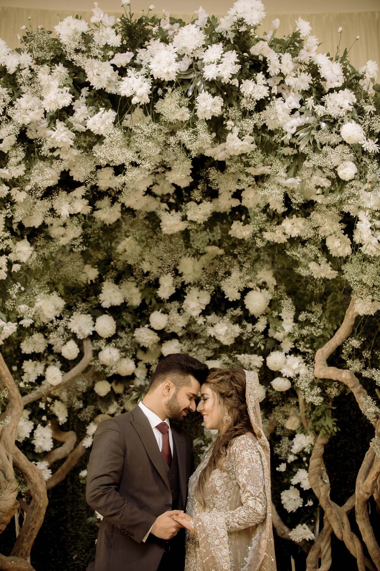 Romantic couple shoot at Dubai Miracle Garden, with vibrant floral backdrops enhancing their love story.