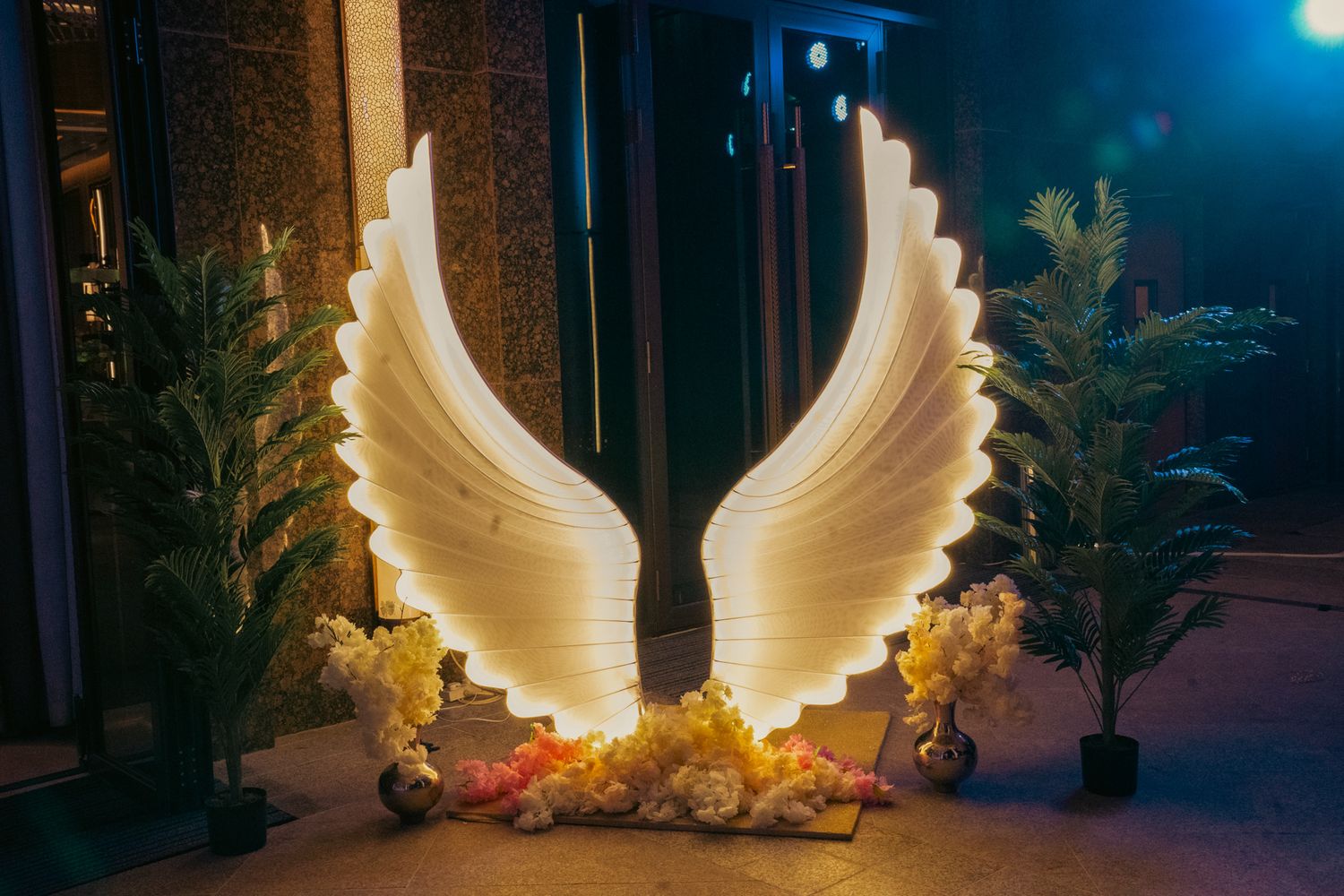 Style reception setup designed to elevate the ambiance of a high-end multicultural wedding celebration picture with wings