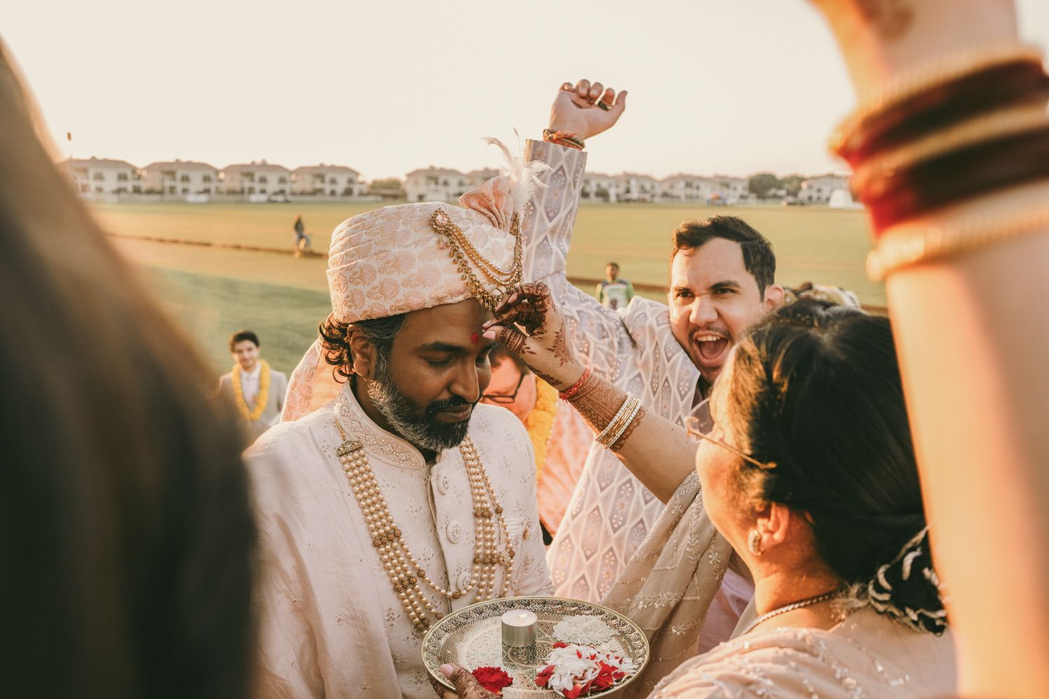 Heartfelt moment captured: bride’s niece giving her a flower, reflecting the deep love and tradition of South Asian weddings.