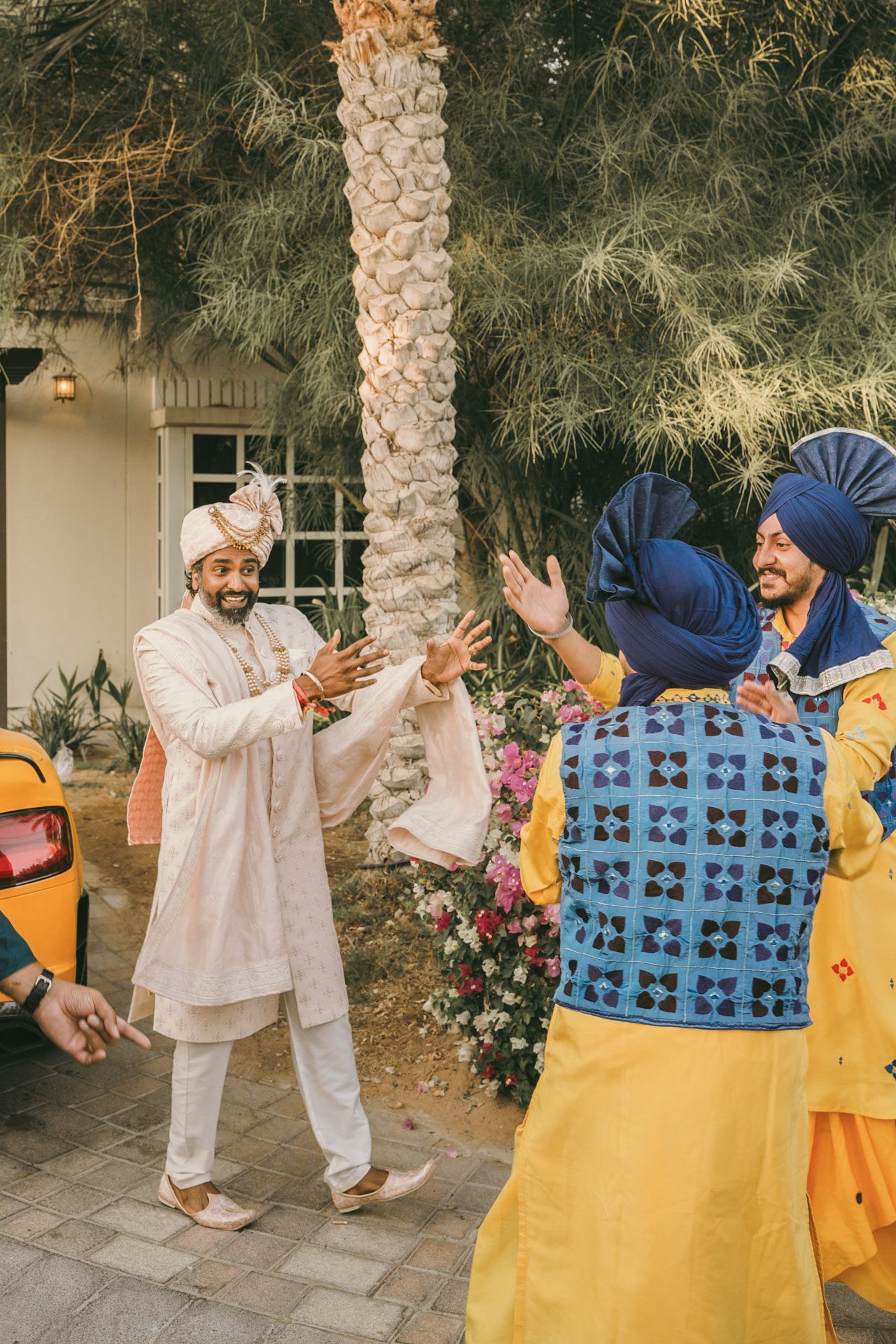Heartfelt moment captured: grandfather holding groom's hand proudly, reflecting the deep love and tradition of South Asian weddings.