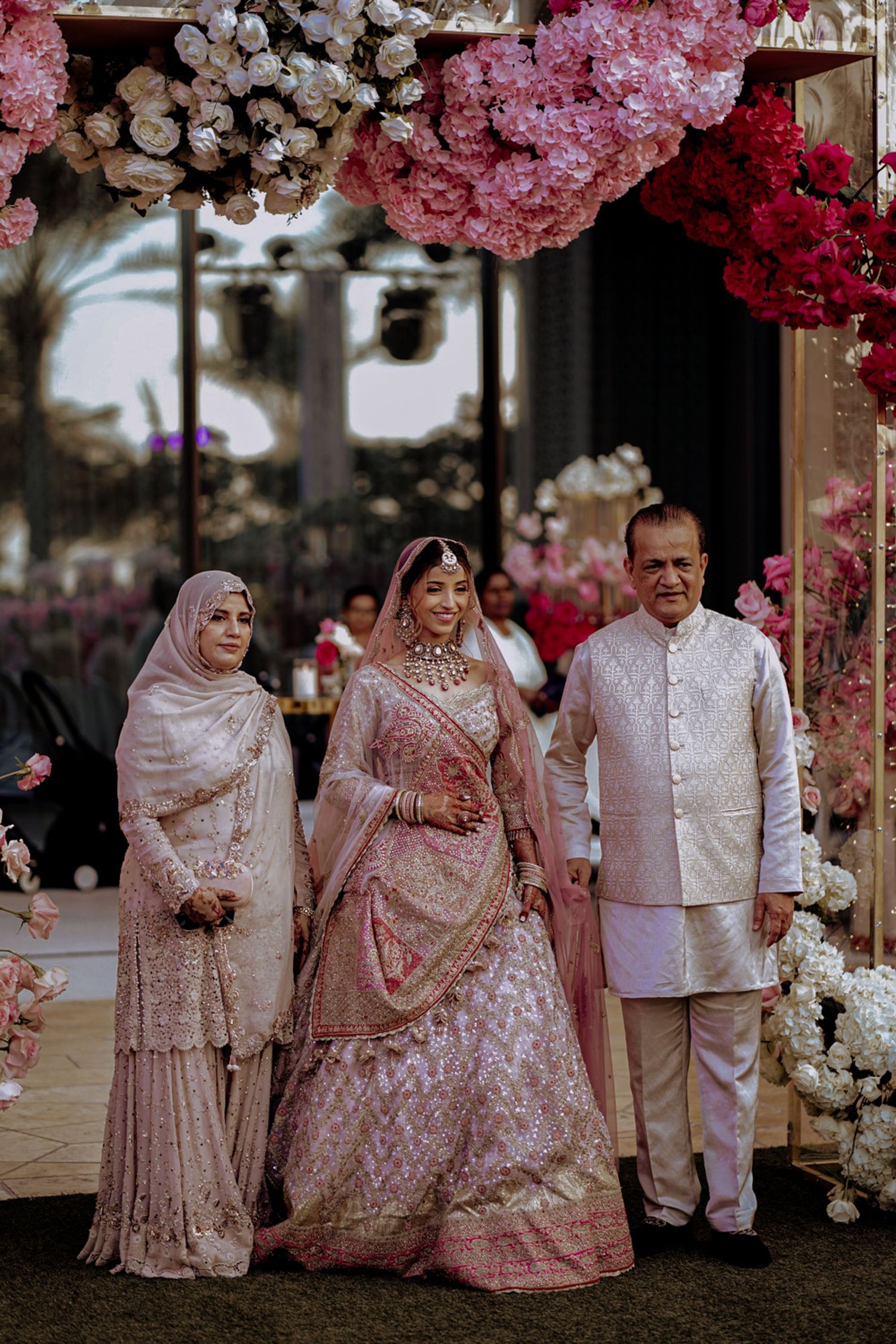 mother and father are blessing the bride at the wedding reception, reflecting the deep love and tradition of Asian wedding