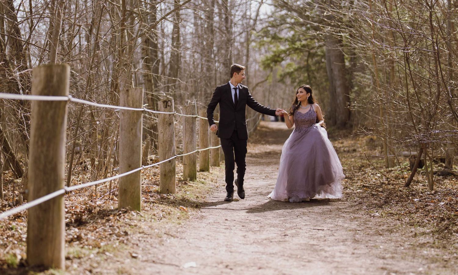 Sweeping romantic shots of a couple walking hand-in-hand through the scenic paths of Guild Inn Estate.