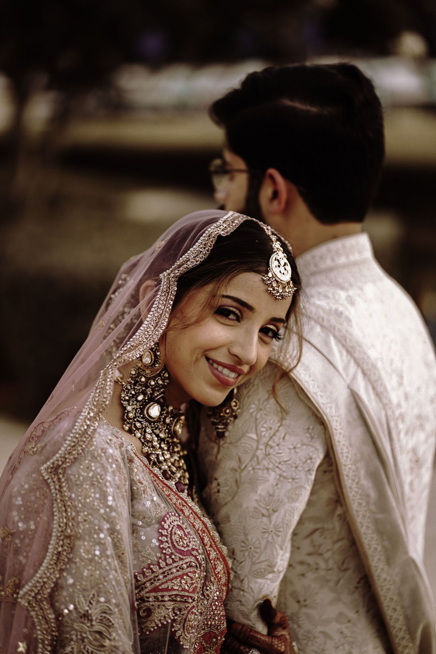 Portrait of the couple wearing classic desi attire during golden hour — a timeless South Asian engagement look.