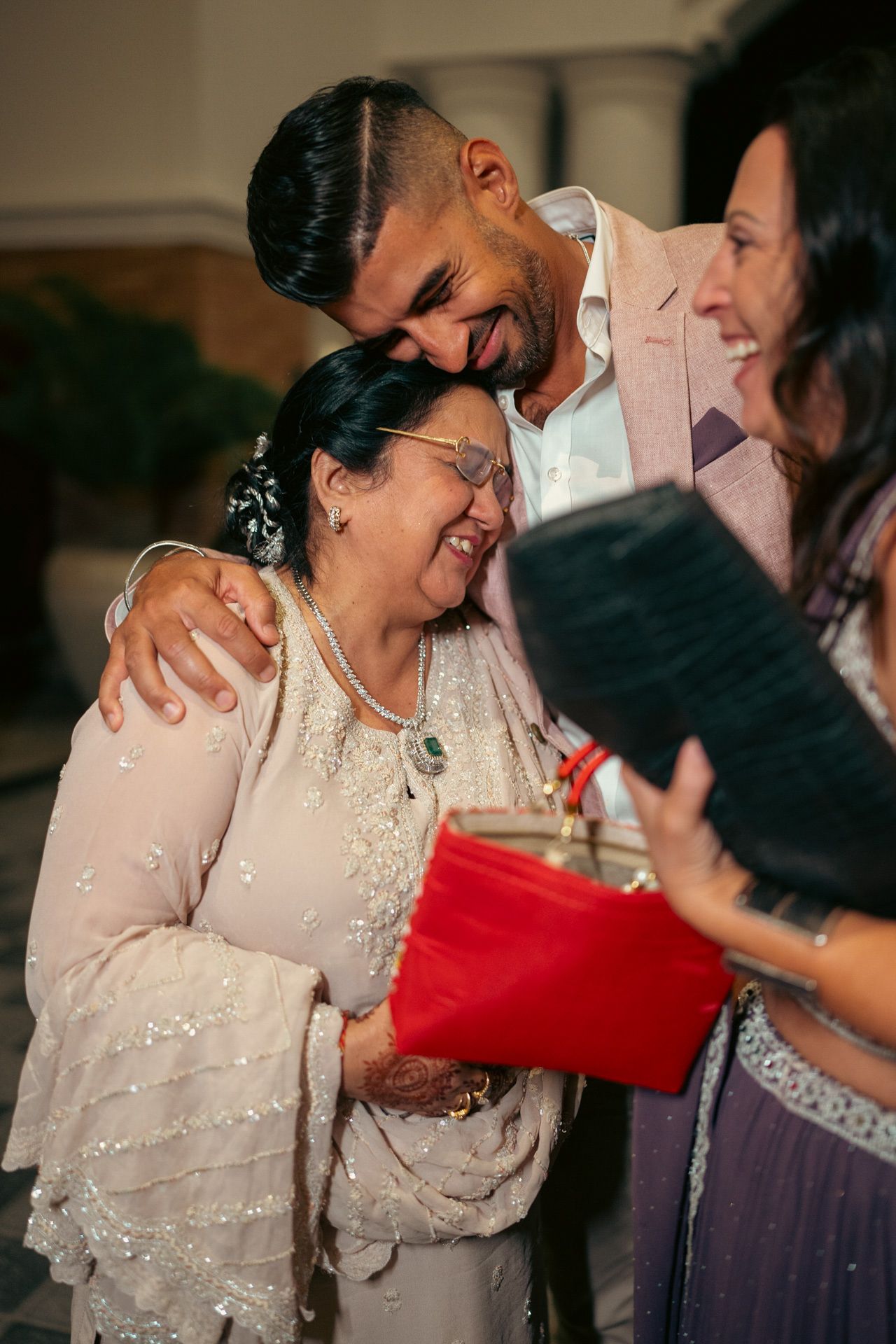 Heartfelt moment captured: elder giving traditional blessings during baraat, reflecting the deep love and tradition of South Asian weddings.