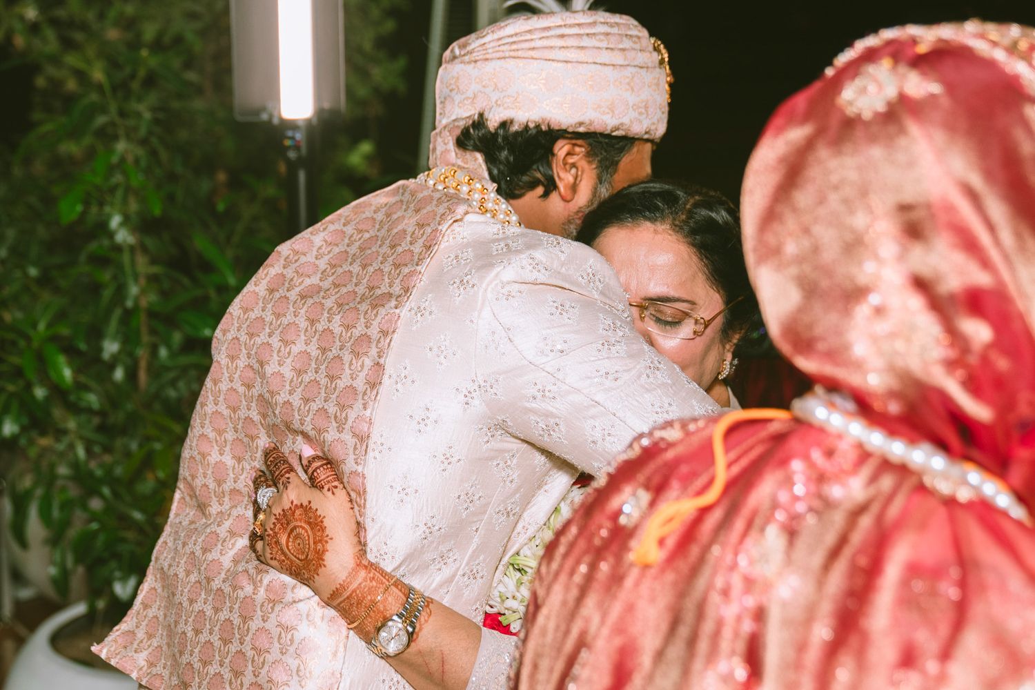 Heartfelt moment captured: mother hugs of son in law, reflecting the deep love and tradition of South Asian weddings.