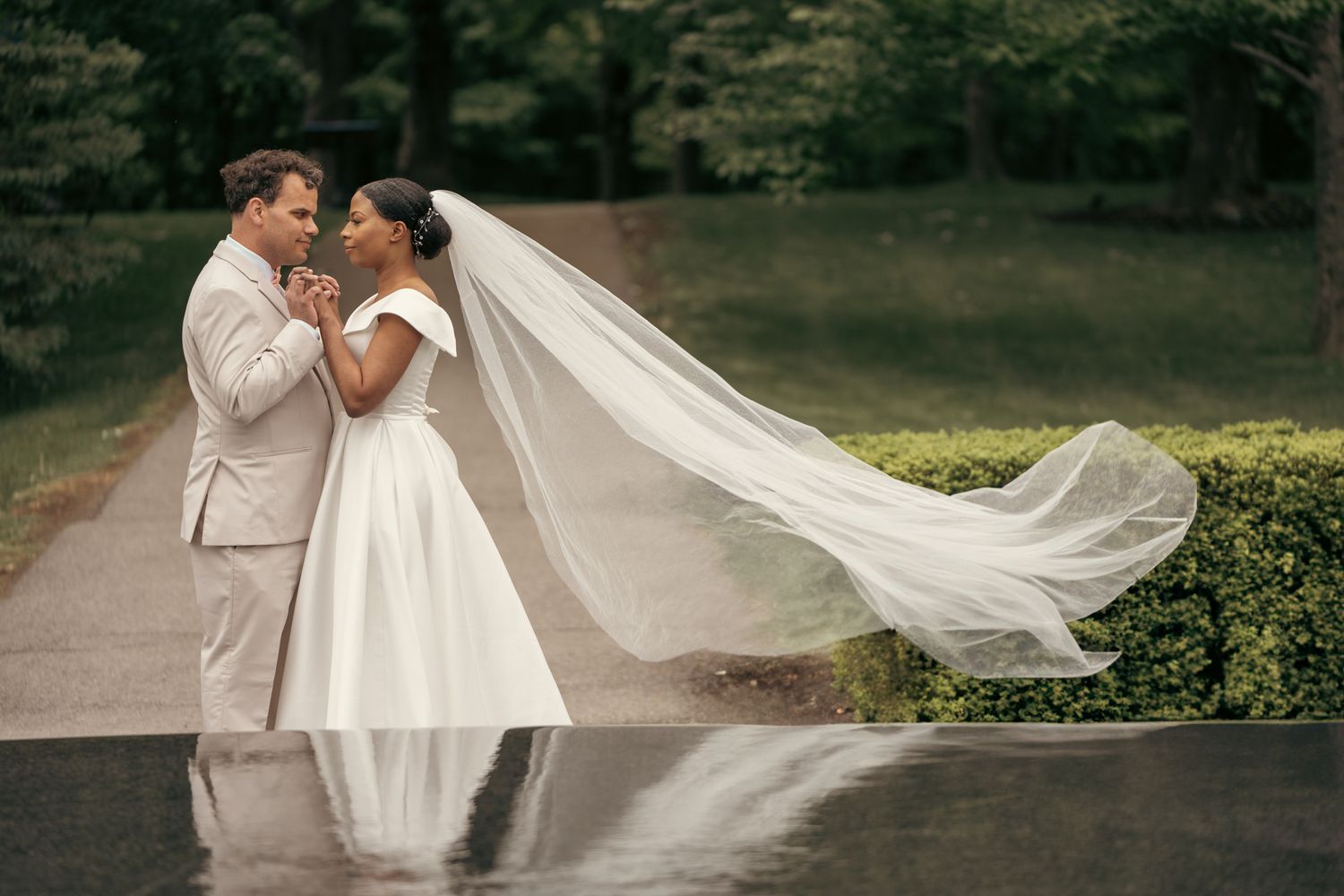 Elegant bridal portrait taken inside a cathedral, showcasing the bride’s lace gown and cathedral-length veil.